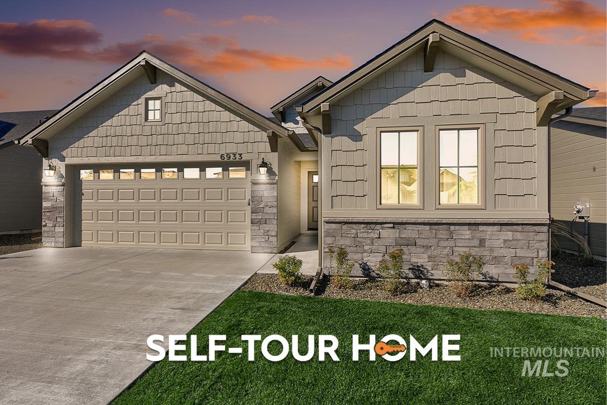 Craftsman inspired home featuring stone siding, a garage, and concrete driveway