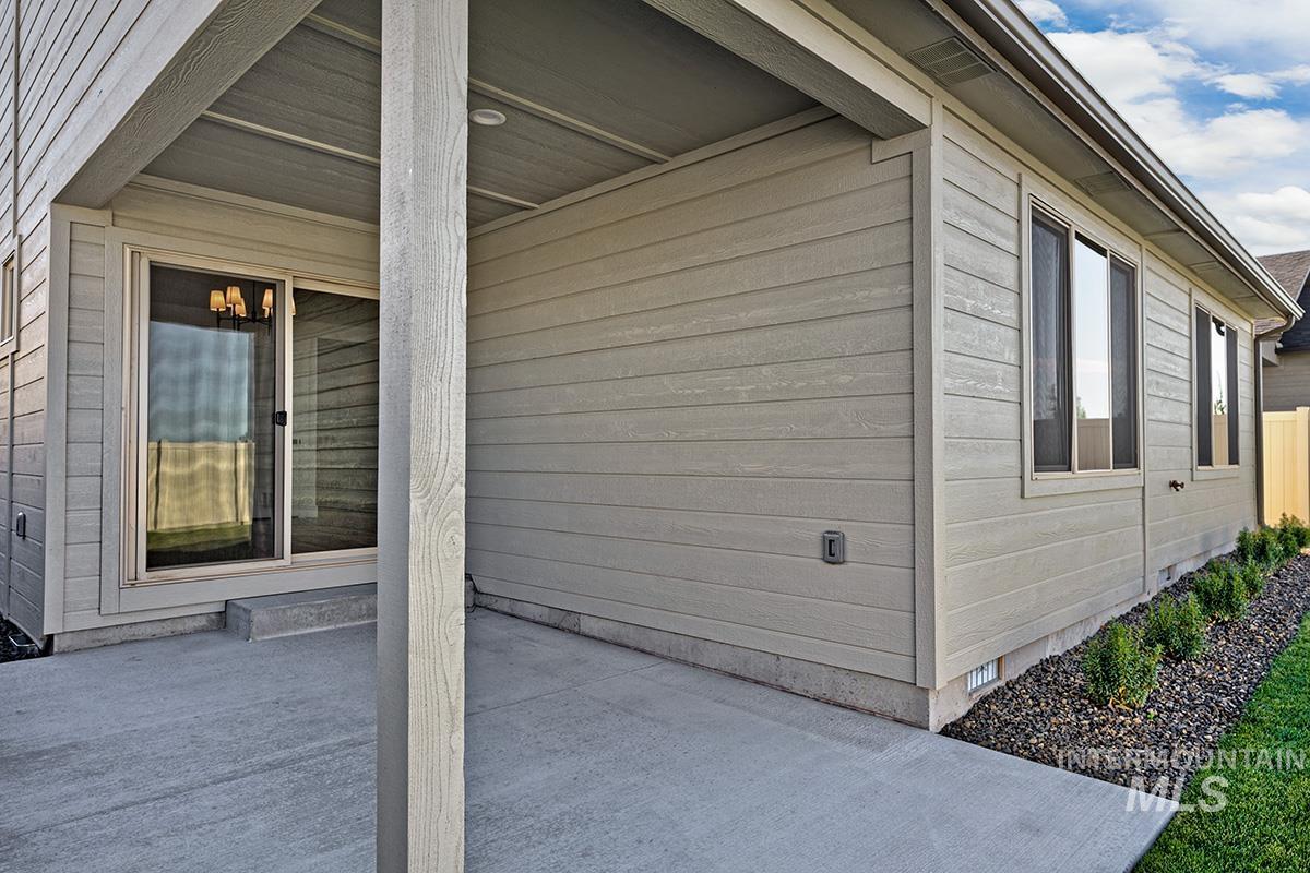 View of side of property with a patio area