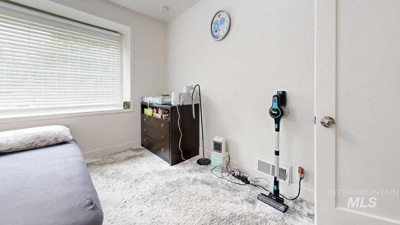 Bedroom with carpet and crown molding