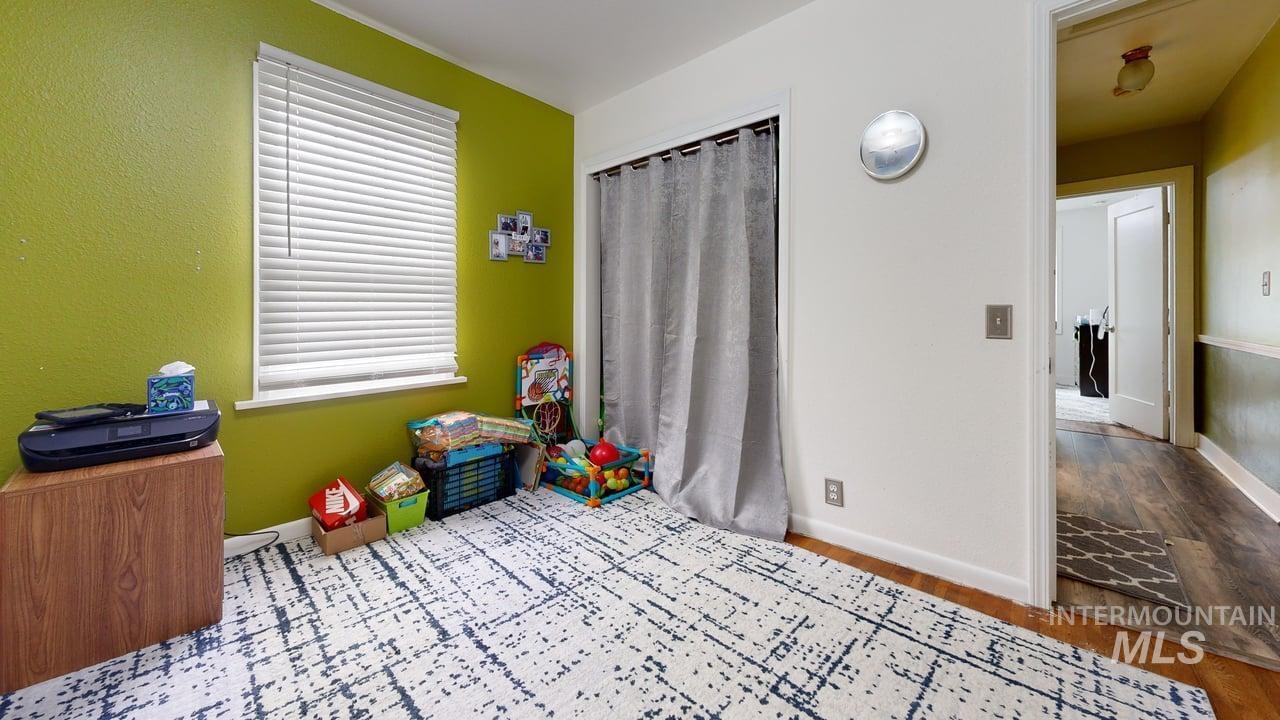 Playroom with wood finished floors and baseboards