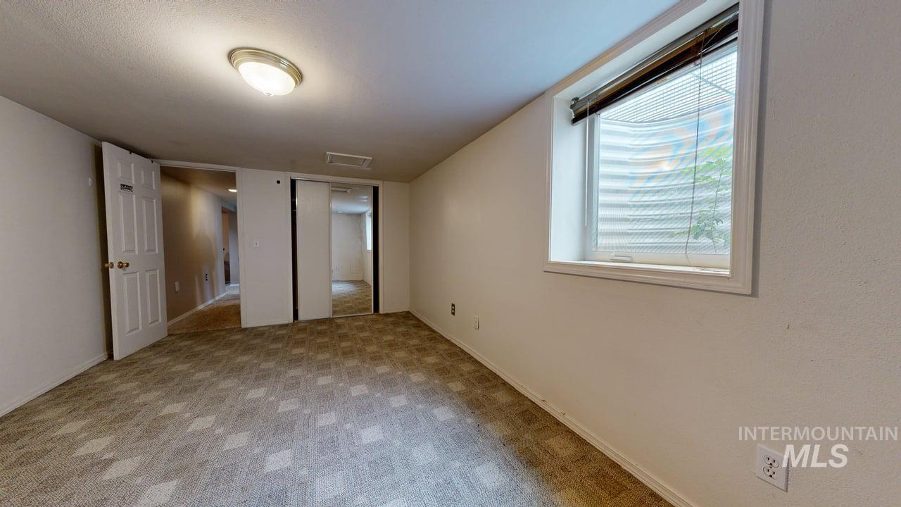 Unfurnished bedroom featuring a closet and light carpet