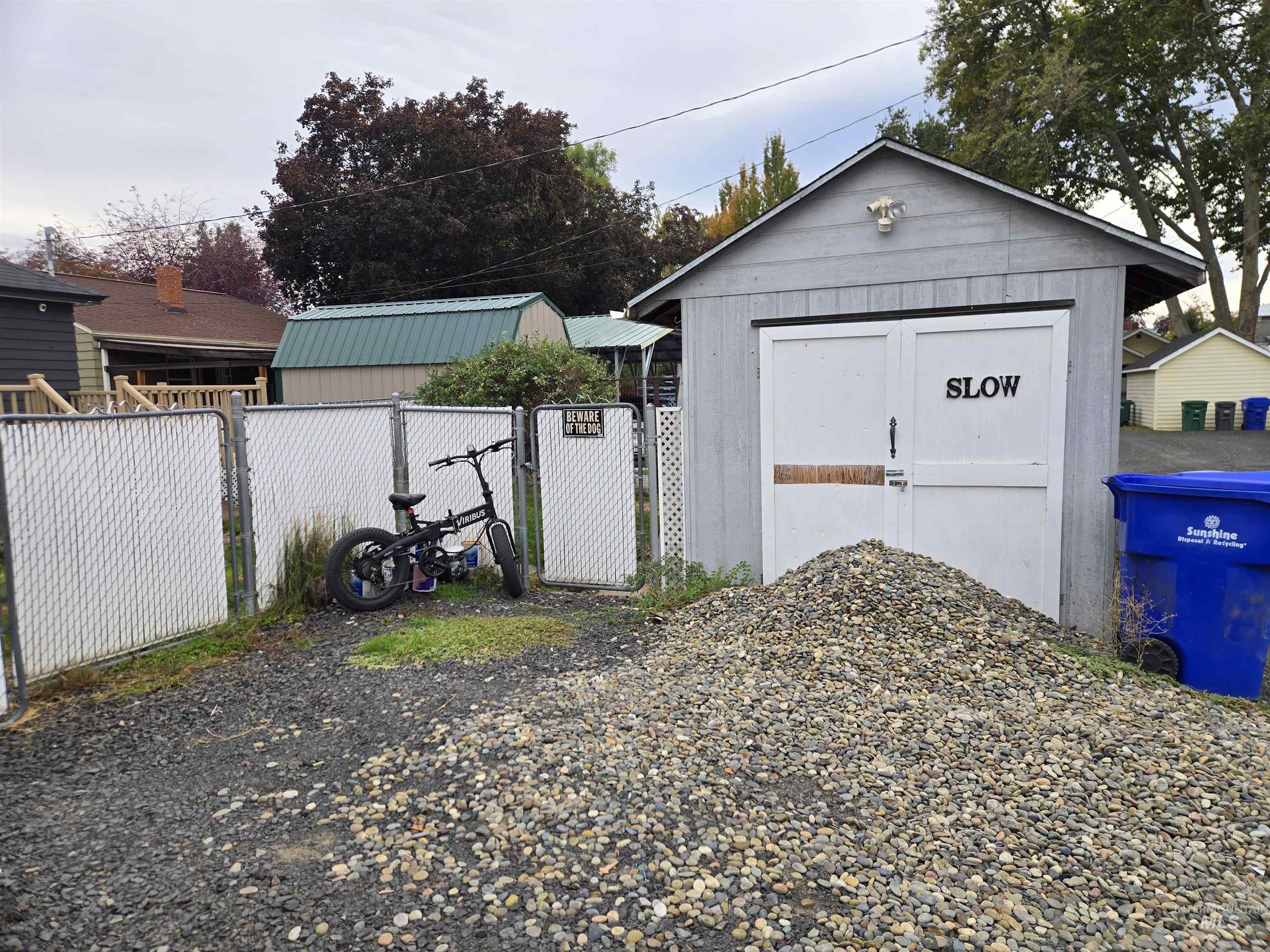 Garage with a gate and a shed