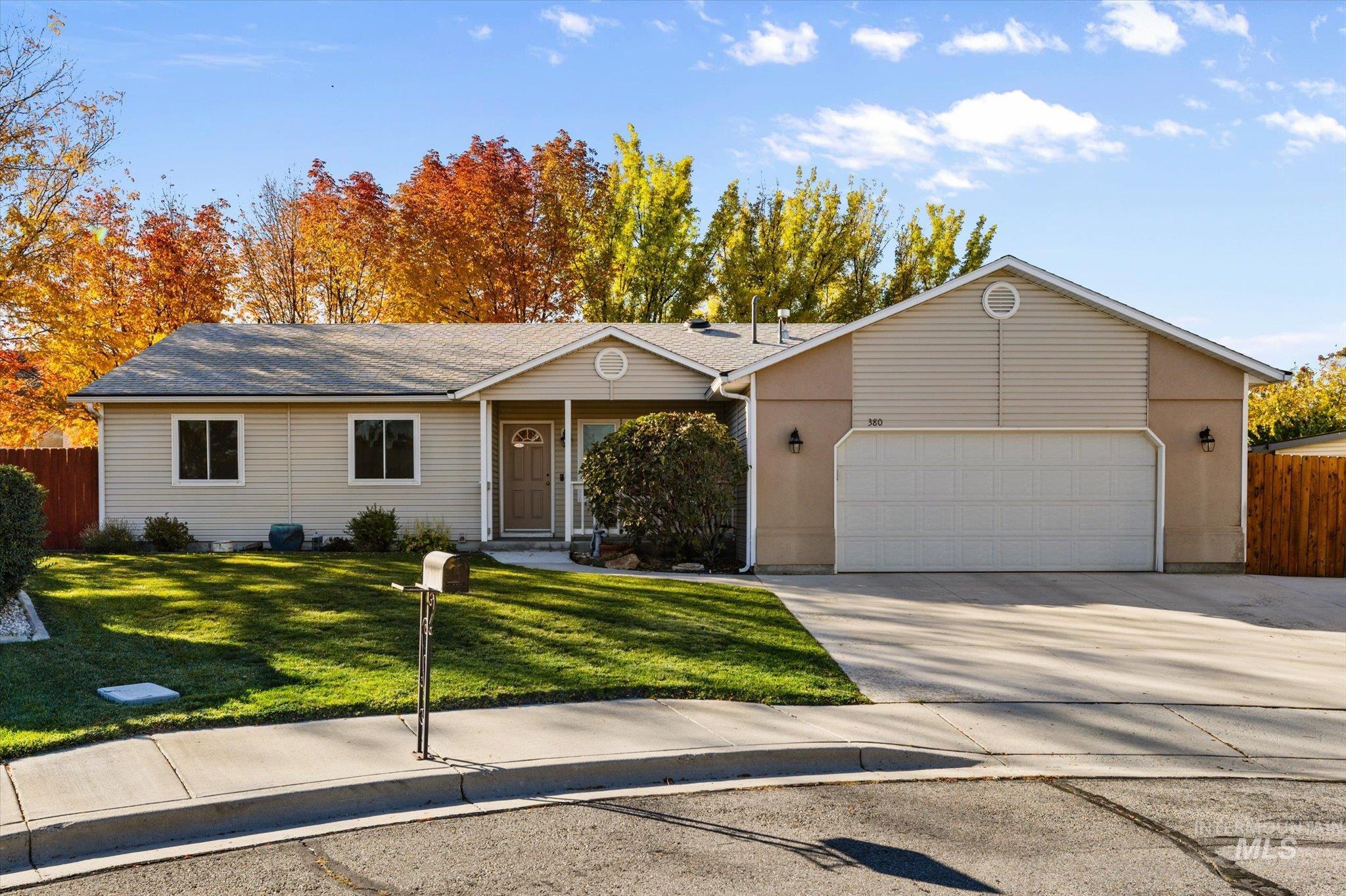 Ranch-style house with concrete driveway and a garage
