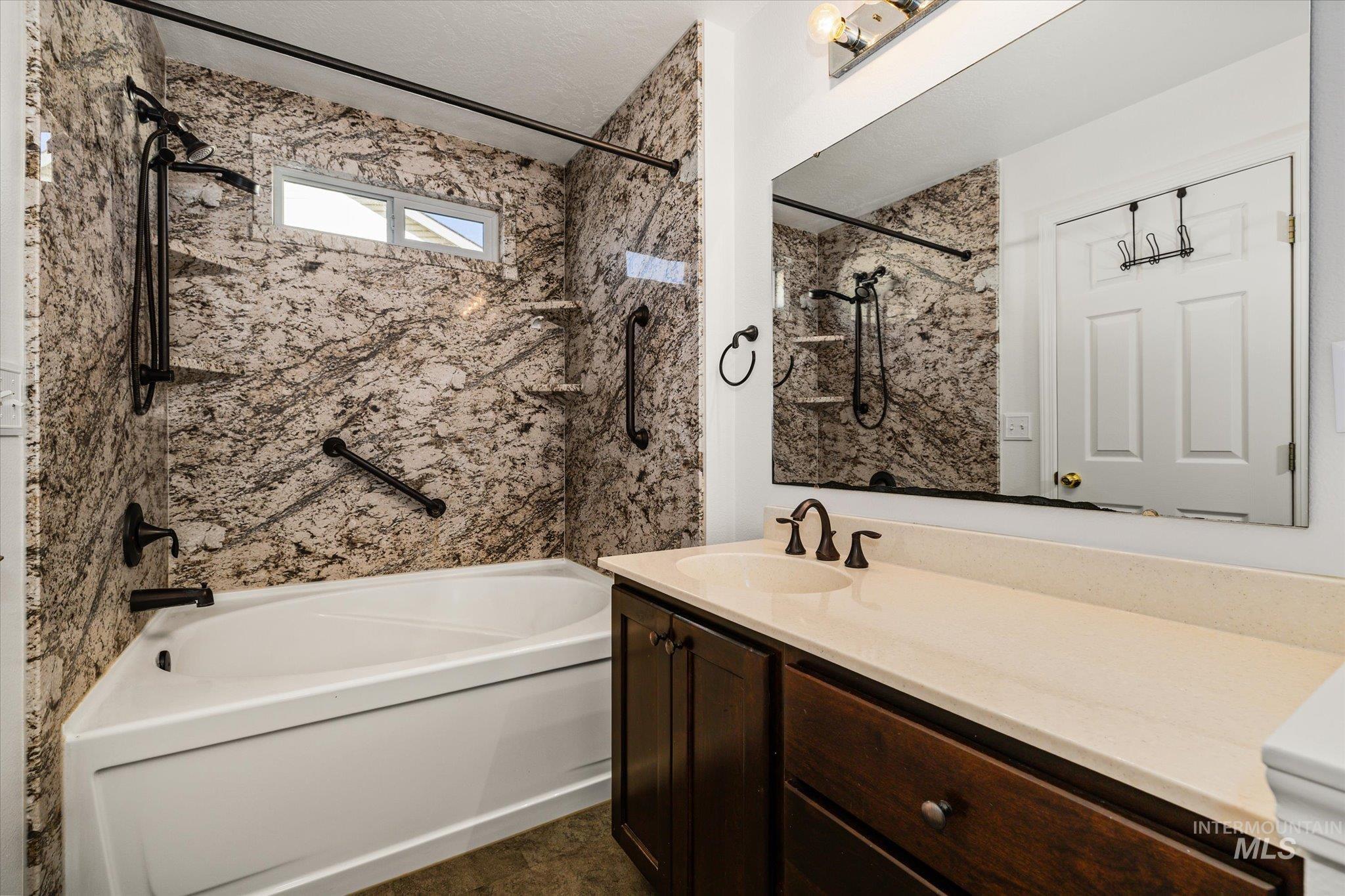 Bathroom with shower / bathtub combination and vanity