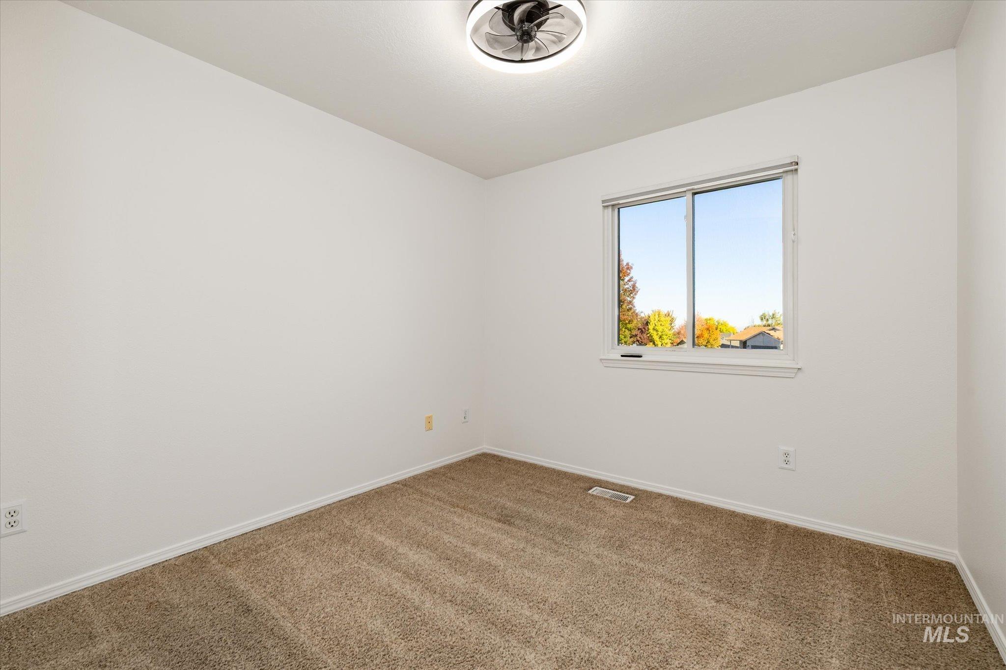 Spare room with carpet flooring and baseboards