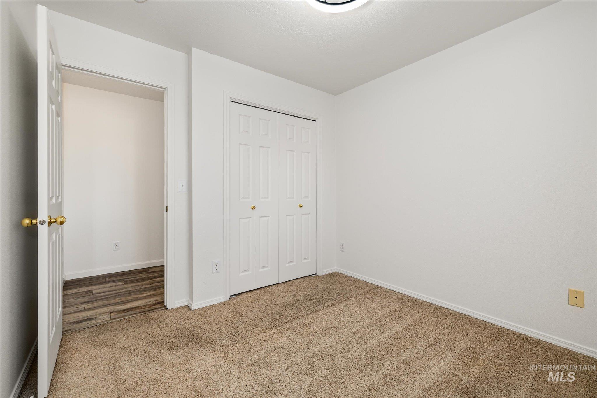 Unfurnished bedroom with carpet floors and a closet