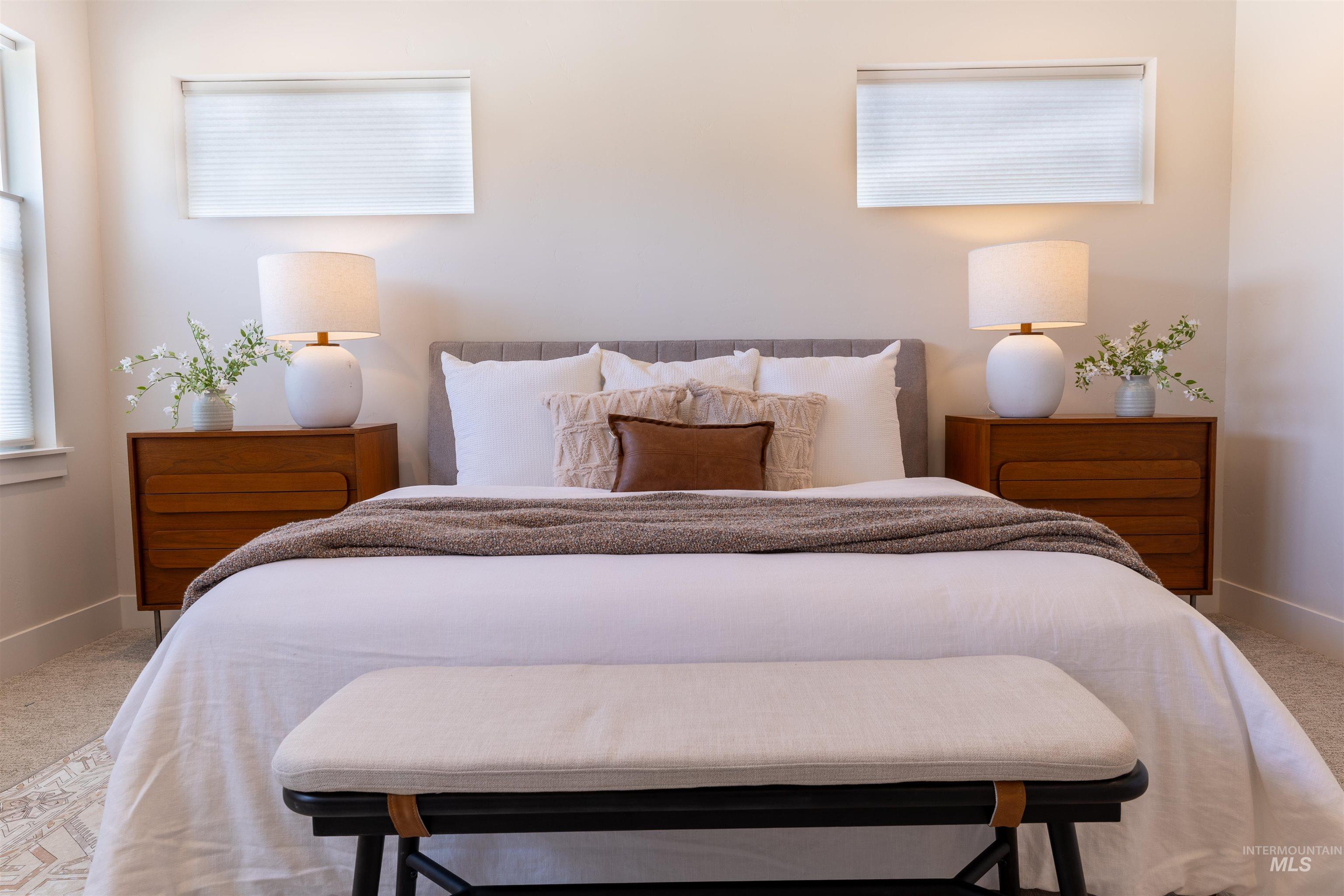 Bedroom featuring light colored carpet