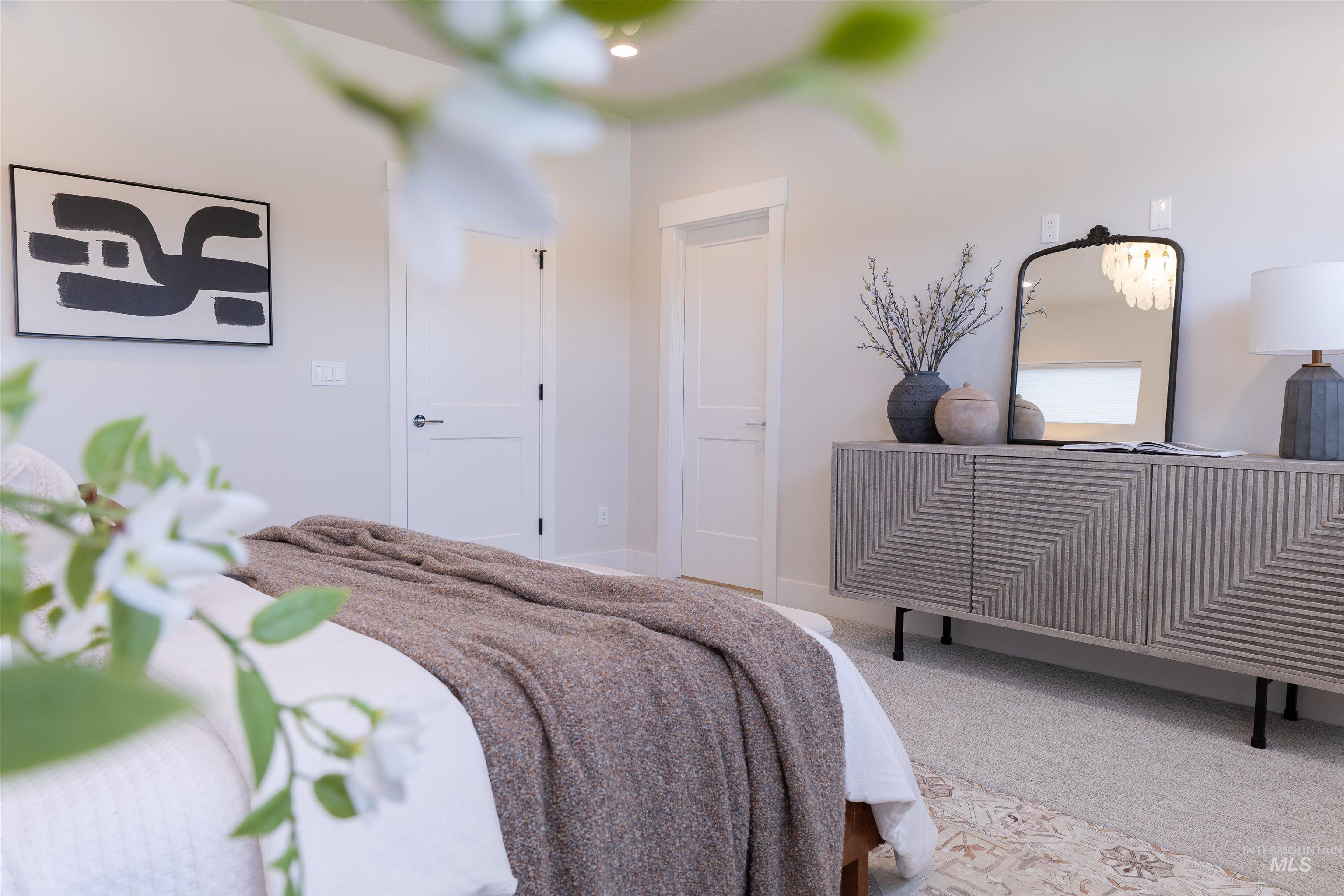 Bedroom featuring carpet floors and baseboards