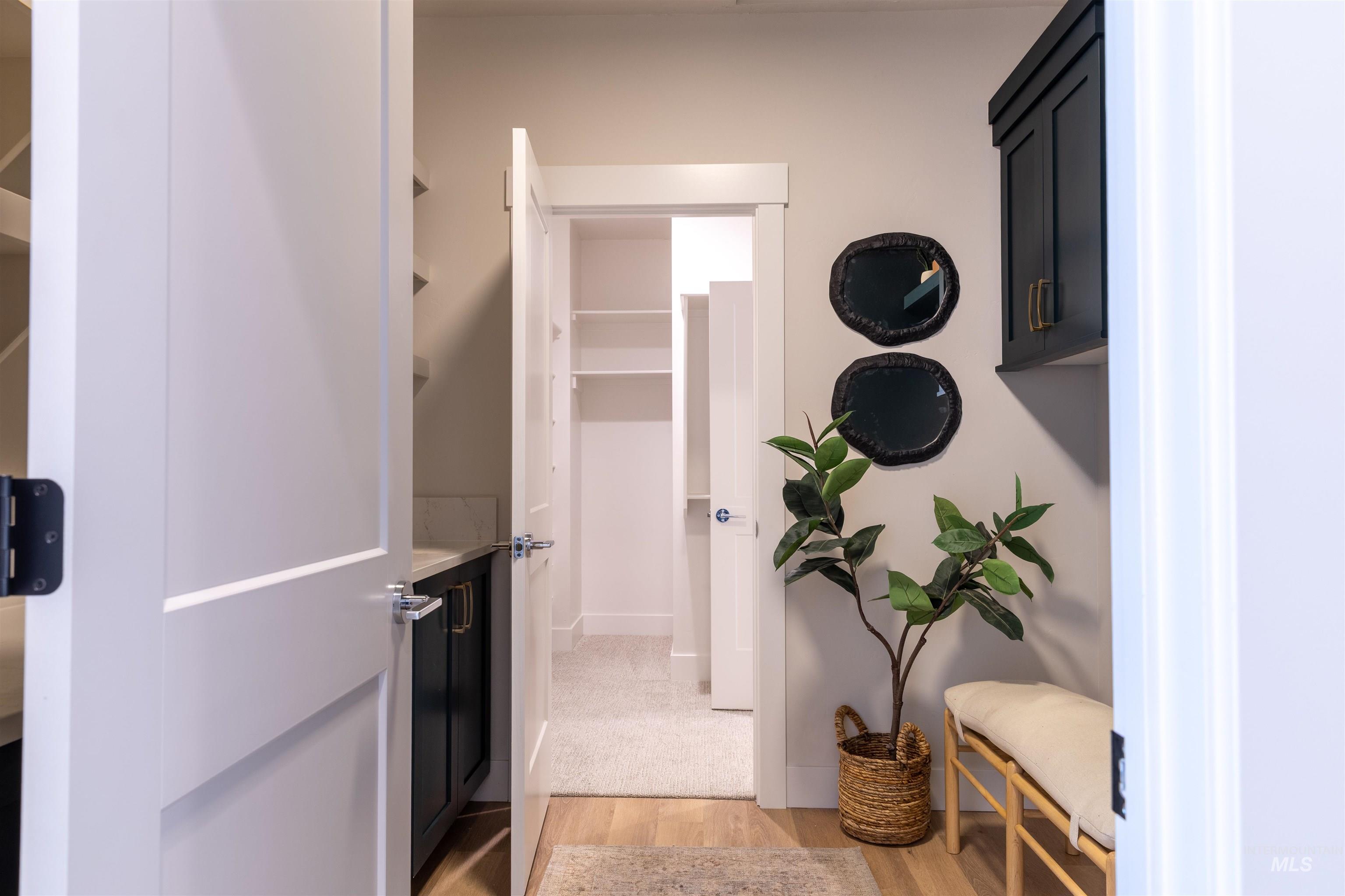 Corridor featuring light wood-style flooring and baseboards