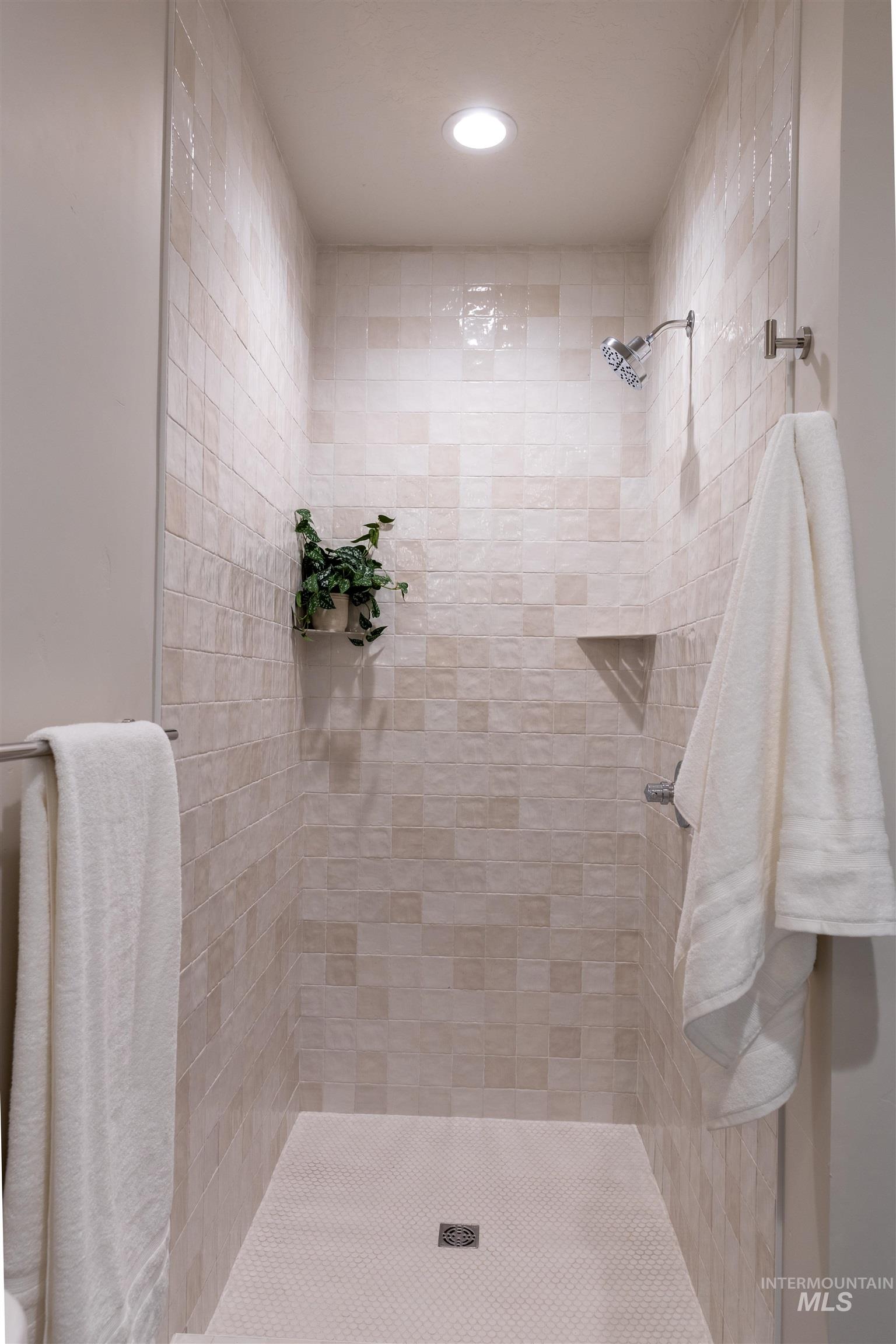 Full bathroom featuring tiled shower and recessed lighting