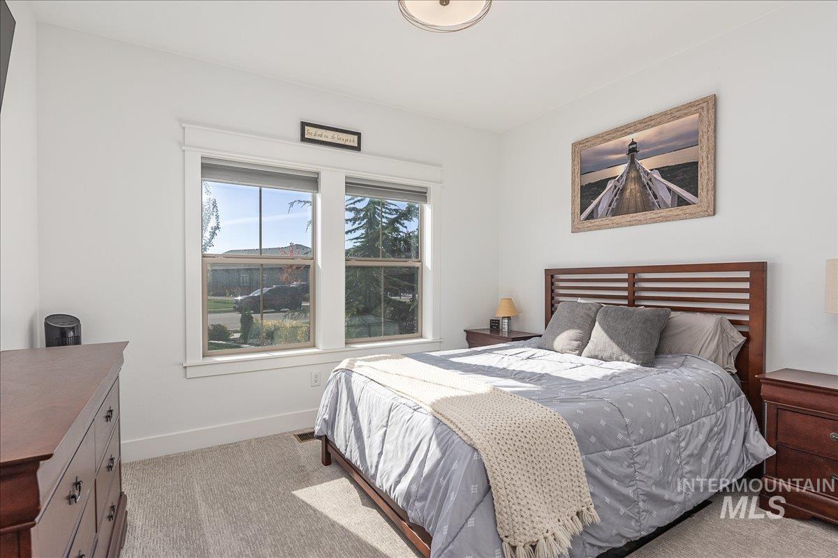 Bedroom featuring baseboards and light colored carpet