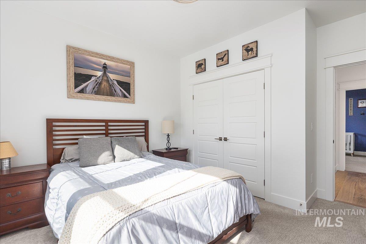 Bedroom featuring light colored carpet and a closet