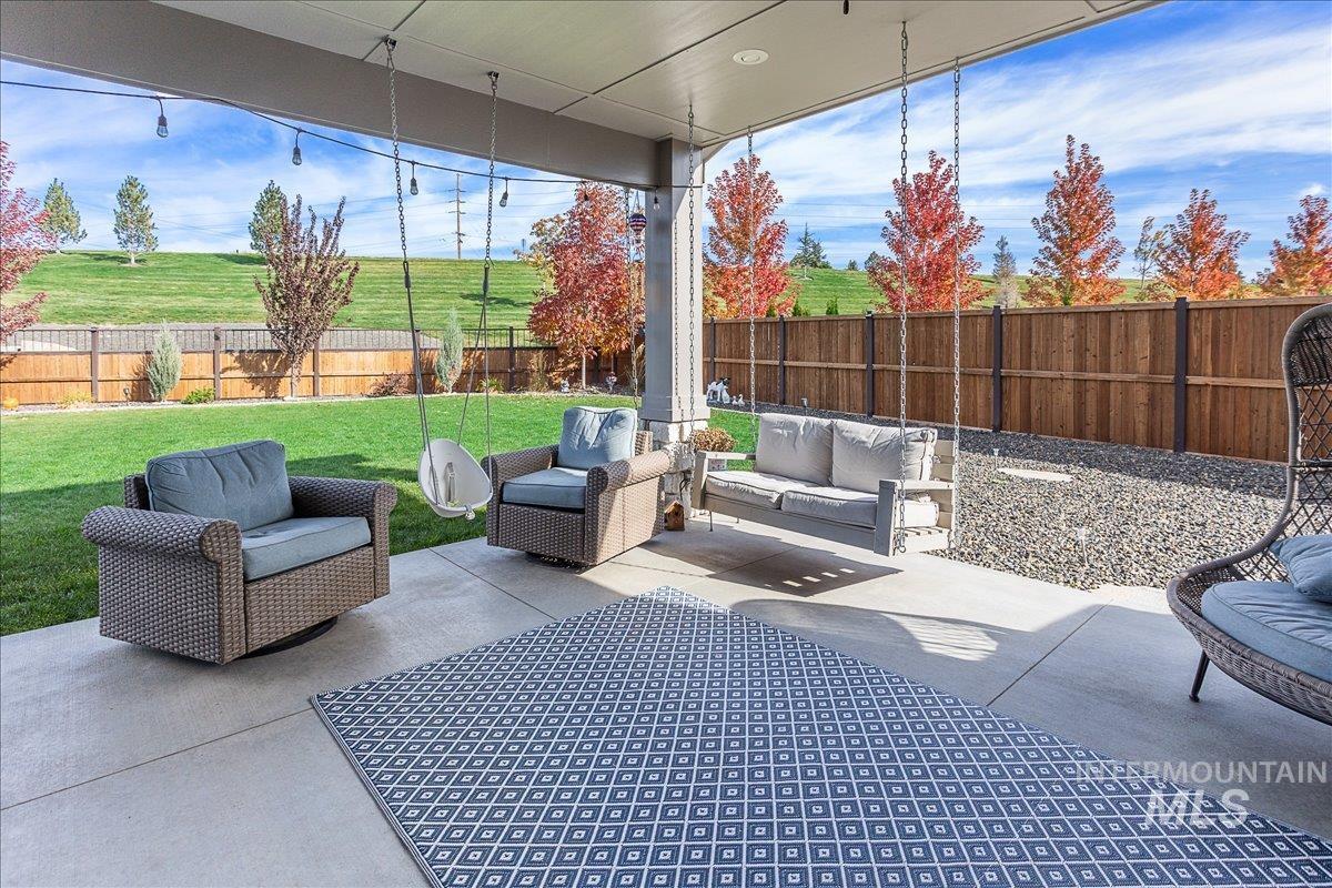Fenced backyard with outdoor lounge area and a patio