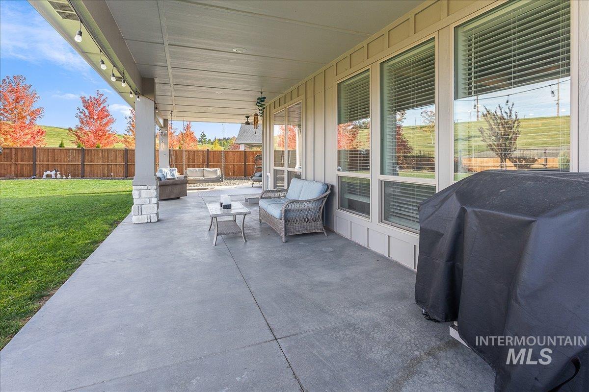 Fenced backyard featuring an outdoor living space, a grill, and a patio