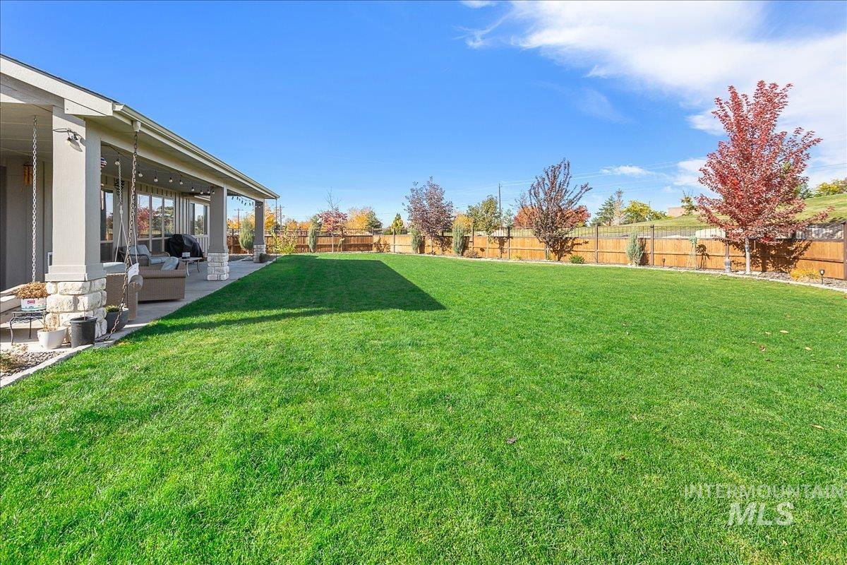 Fenced backyard with a patio area