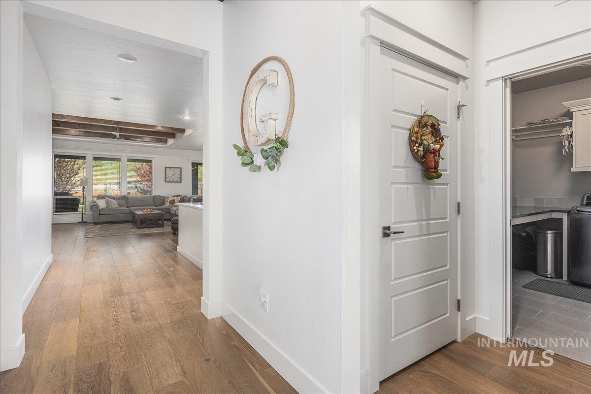 Hall with dark wood finished floors and baseboards