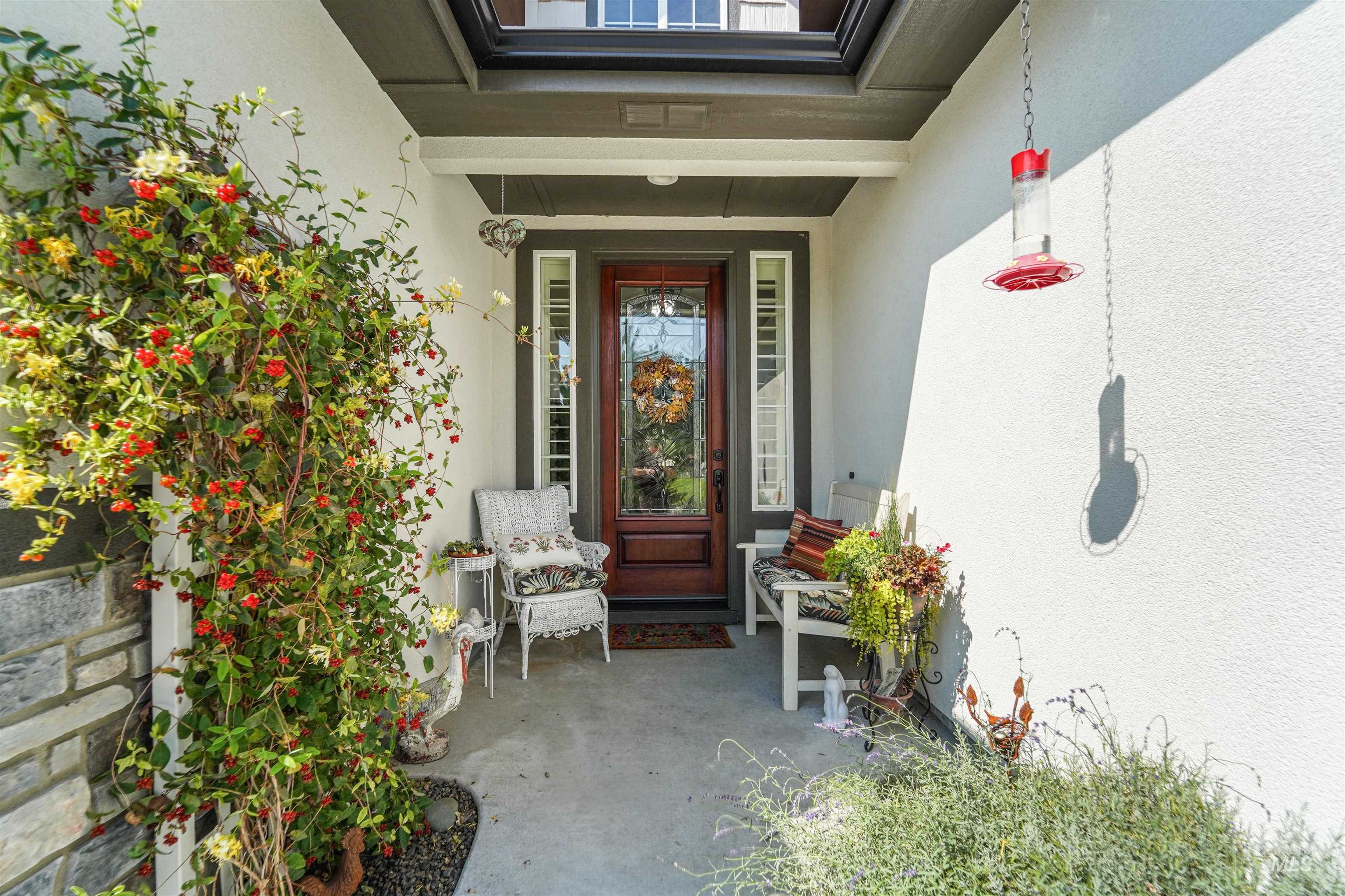 Doorway to property with stucco siding and covered porch