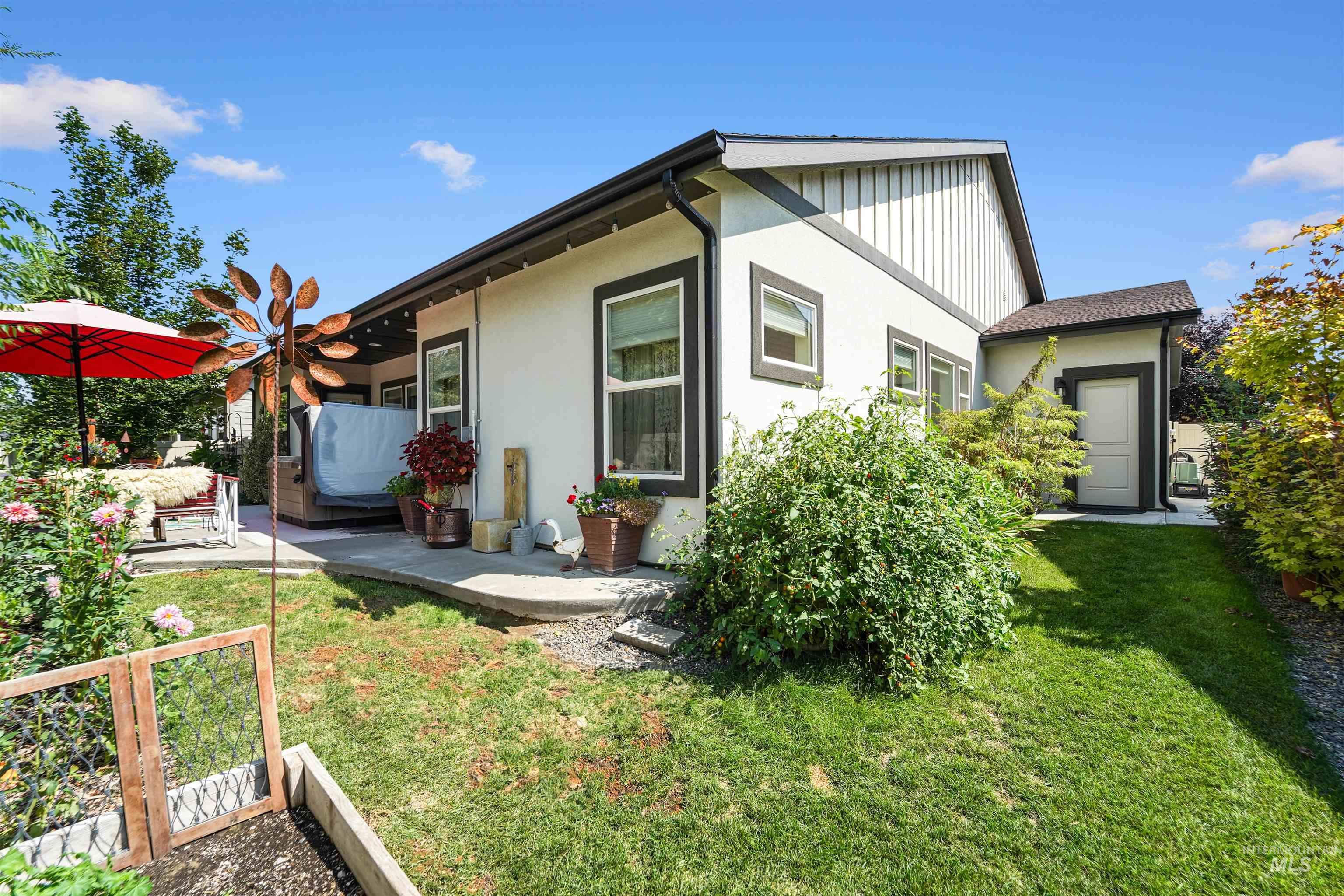 View of home's exterior with a patio area, a yard, and stucco siding