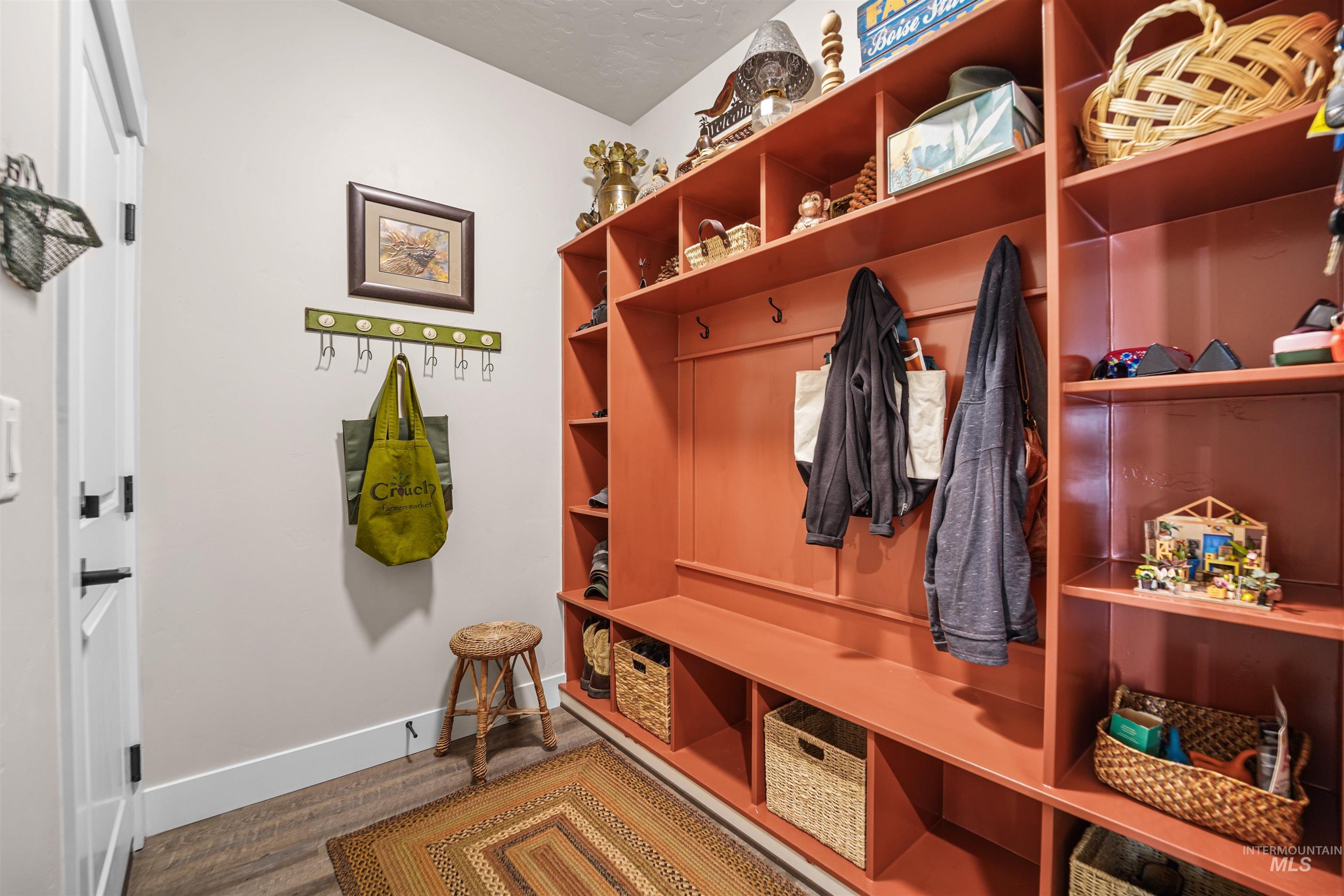 Mudroom with baseboards and wood finished floors