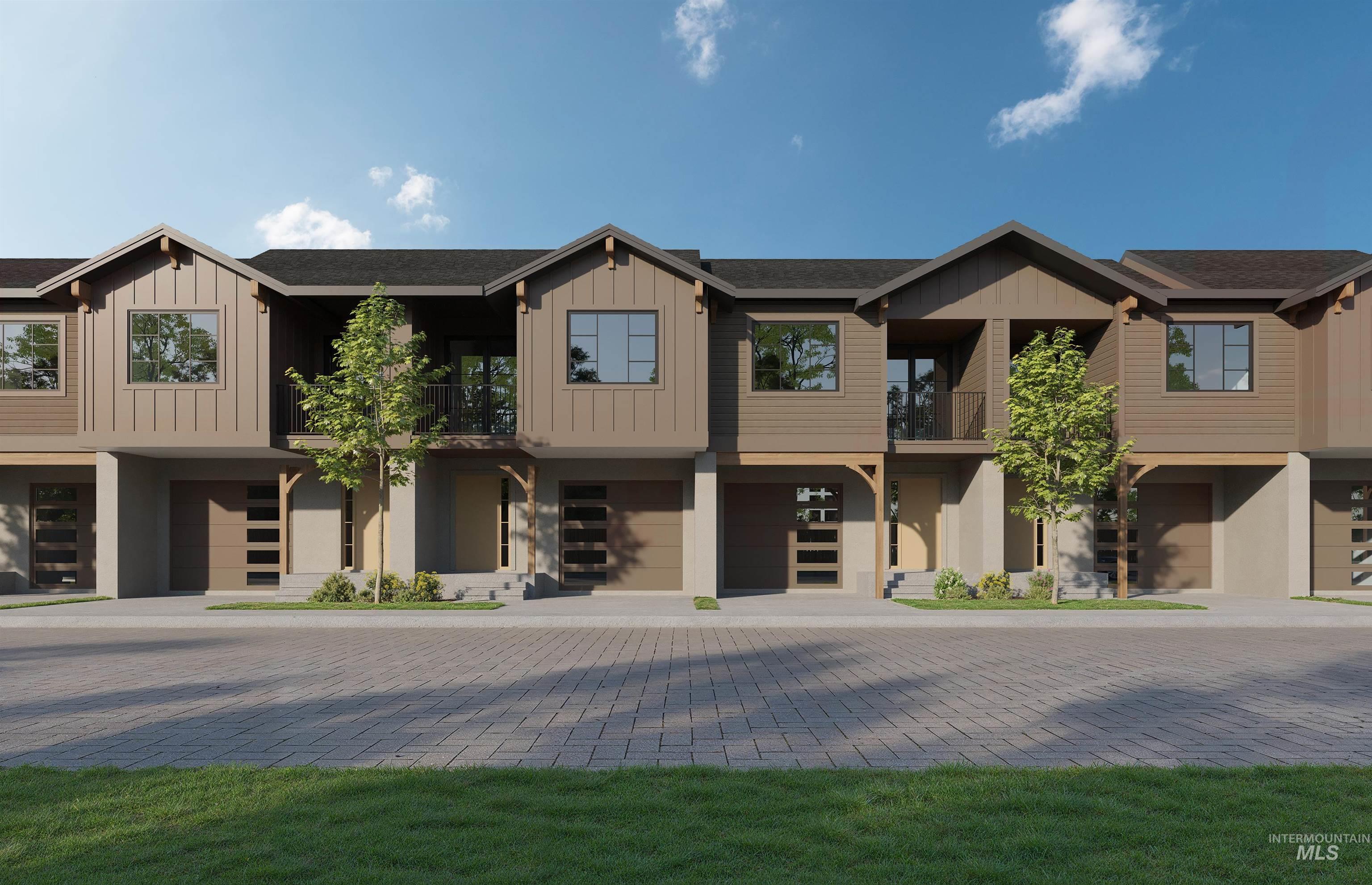 View of front of property with a balcony, an attached garage, board and batten siding, and driveway