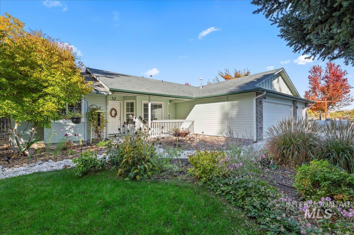 View of front of property with an attached garage and a front lawn