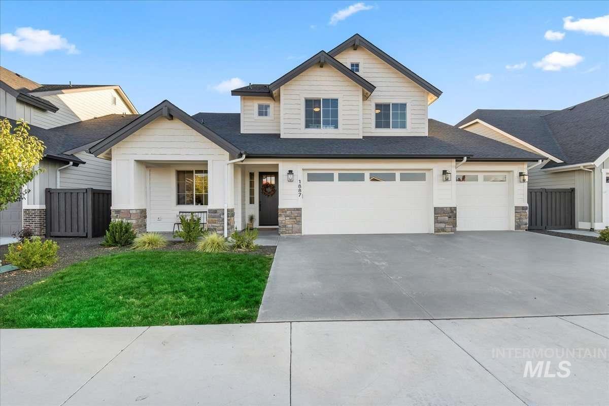 Craftsman-style home with stone siding and driveway