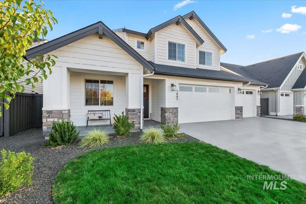 Craftsman inspired home with stone siding, concrete driveway, a garage, and covered porch