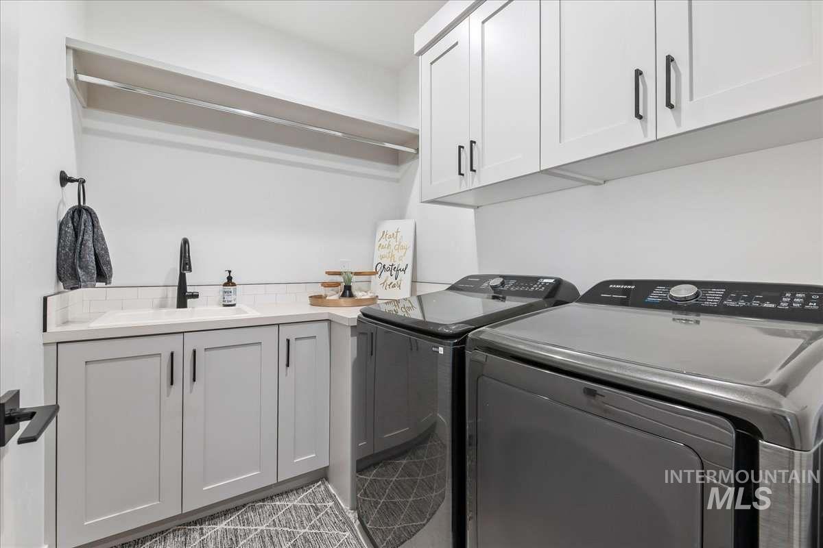 Laundry area with cabinet space and independent washer and dryer