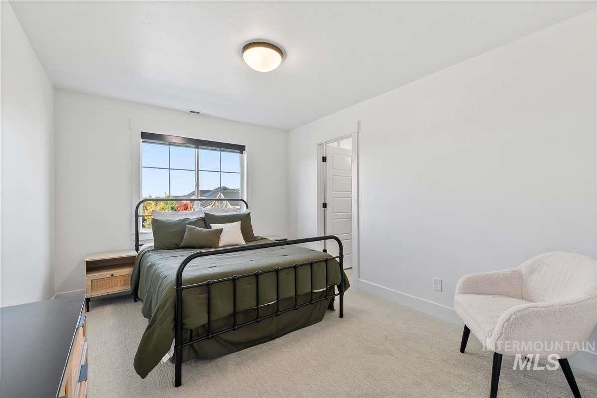 Bedroom featuring carpet floors and baseboards