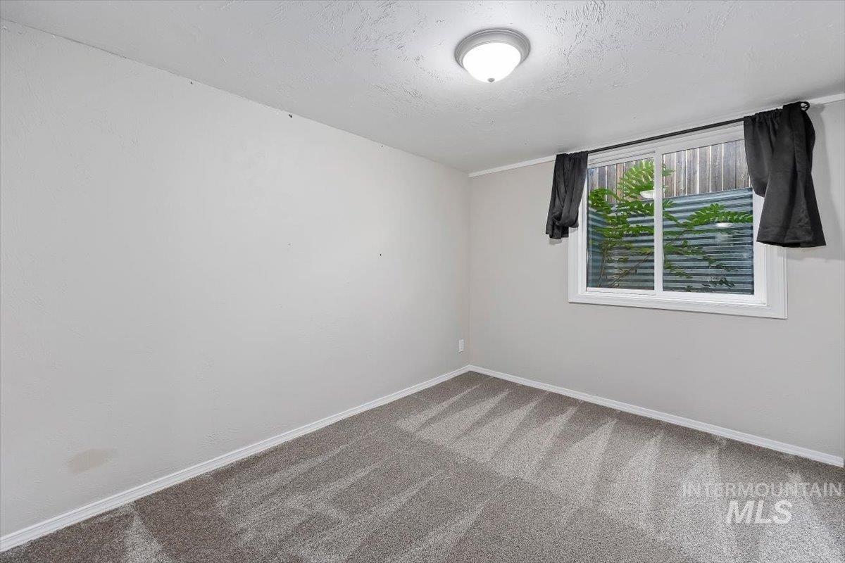 Spare room with carpet floors and a textured ceiling