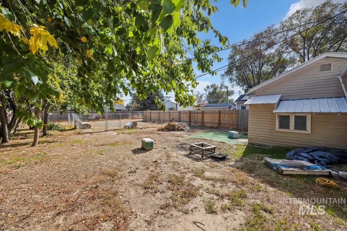 Fenced backyard with a fire pit