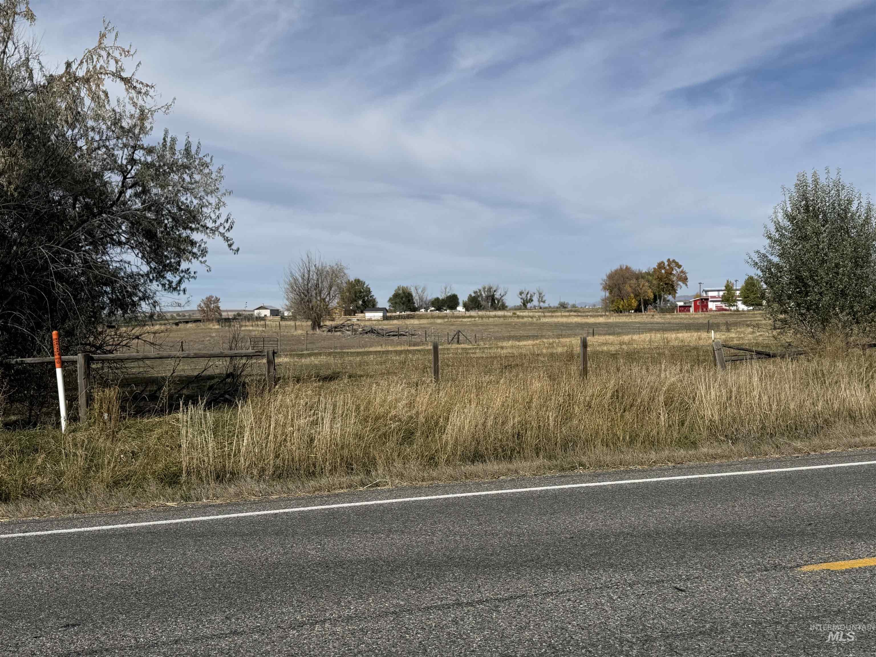 View of asphalt street with a rural view