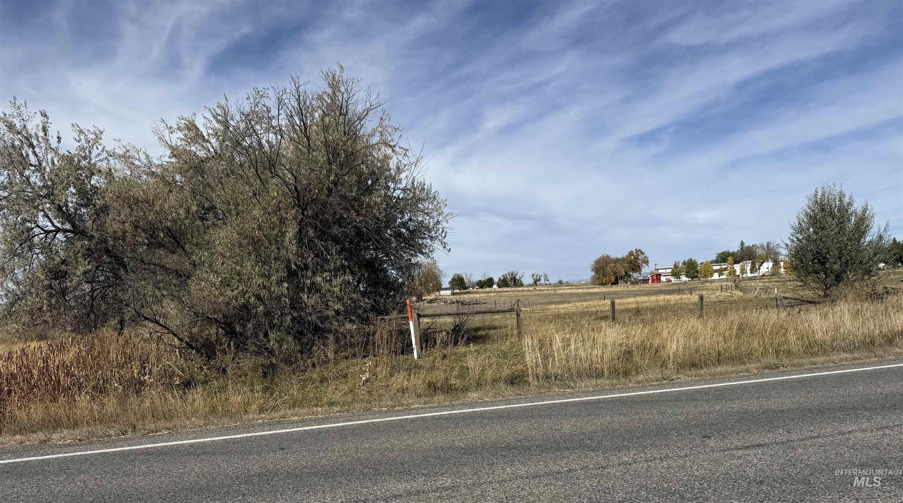 View of asphalt road with a view of rural / pastoral area