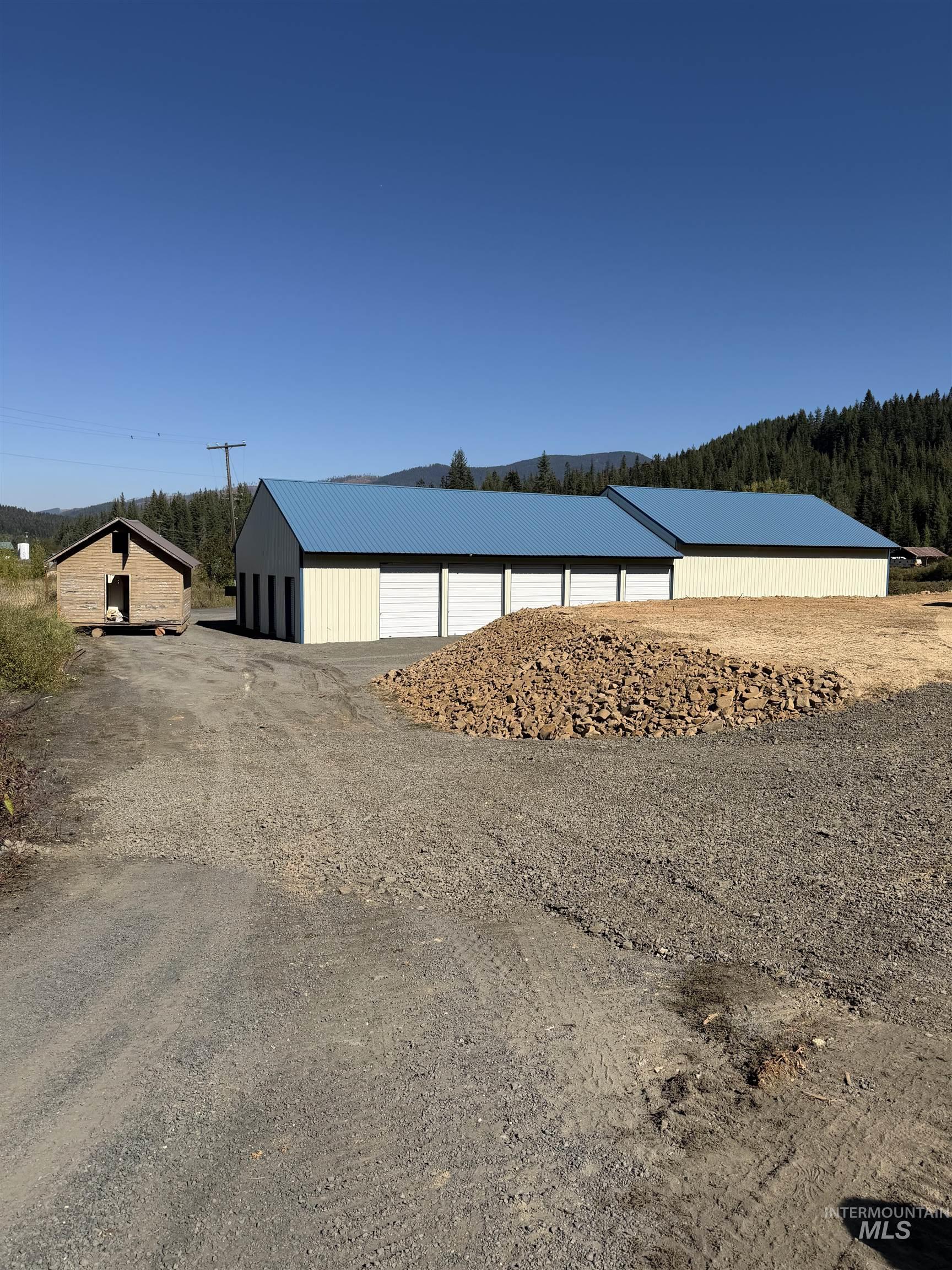 Water view with an outbuilding and a forest