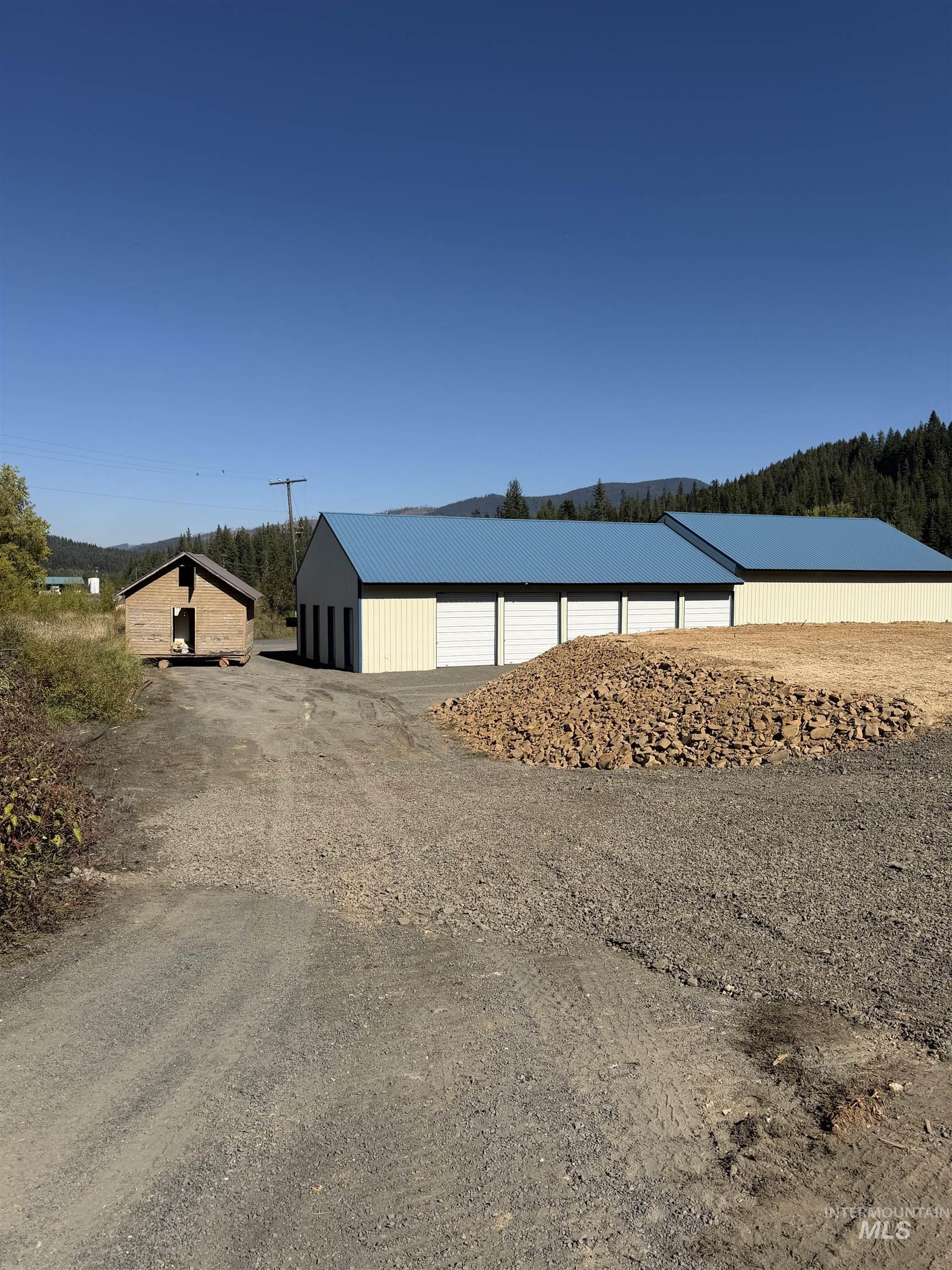 Water view featuring a pole building and a forest