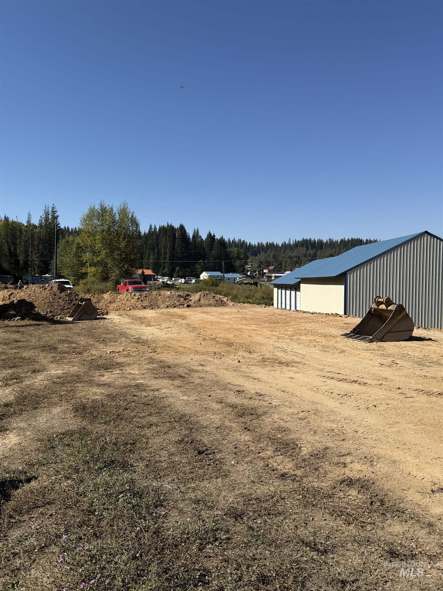 View of yard with an outbuilding, an outdoor structure, and a wooded view