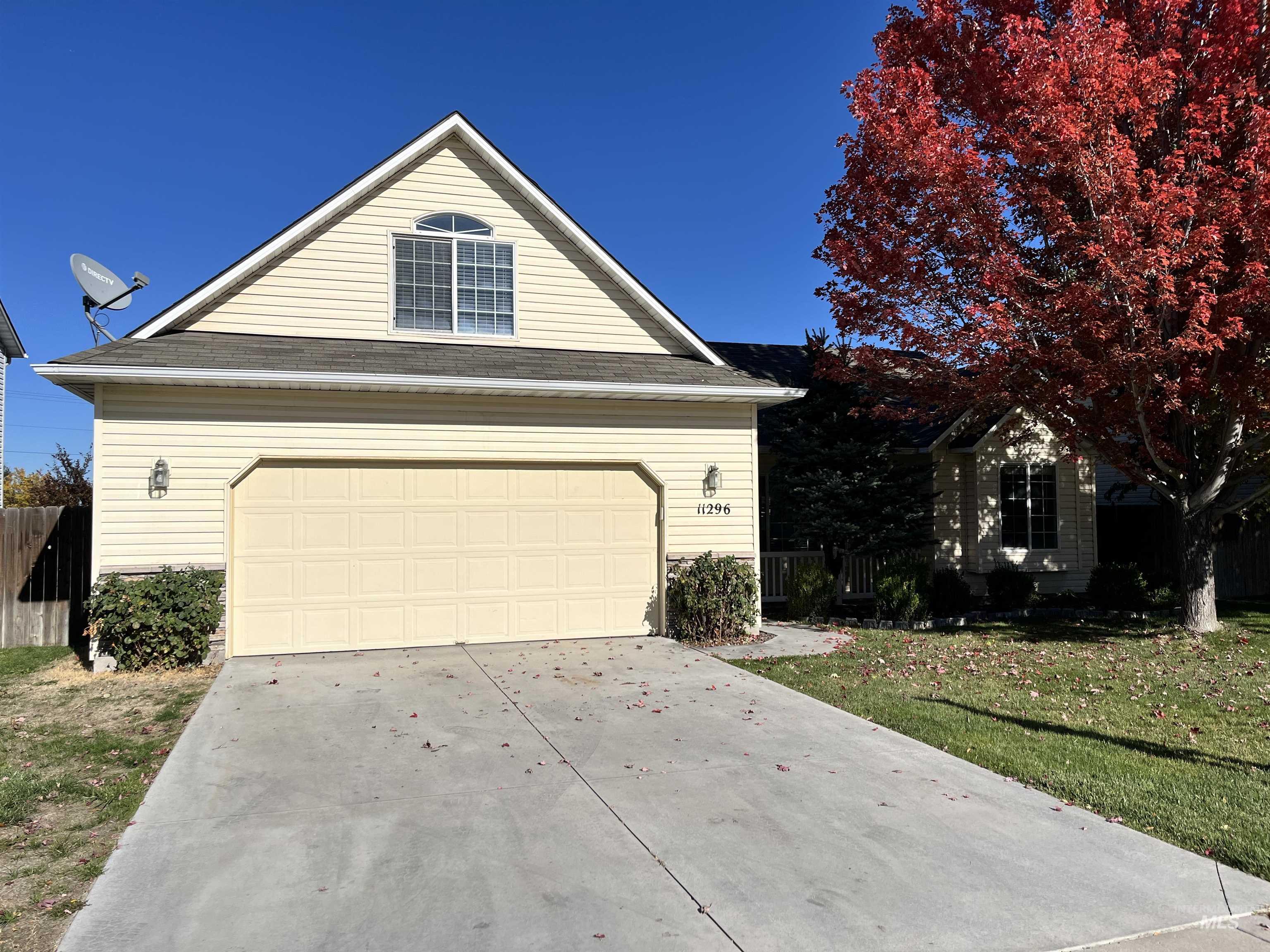 View of front facade with concrete driveway and a garage