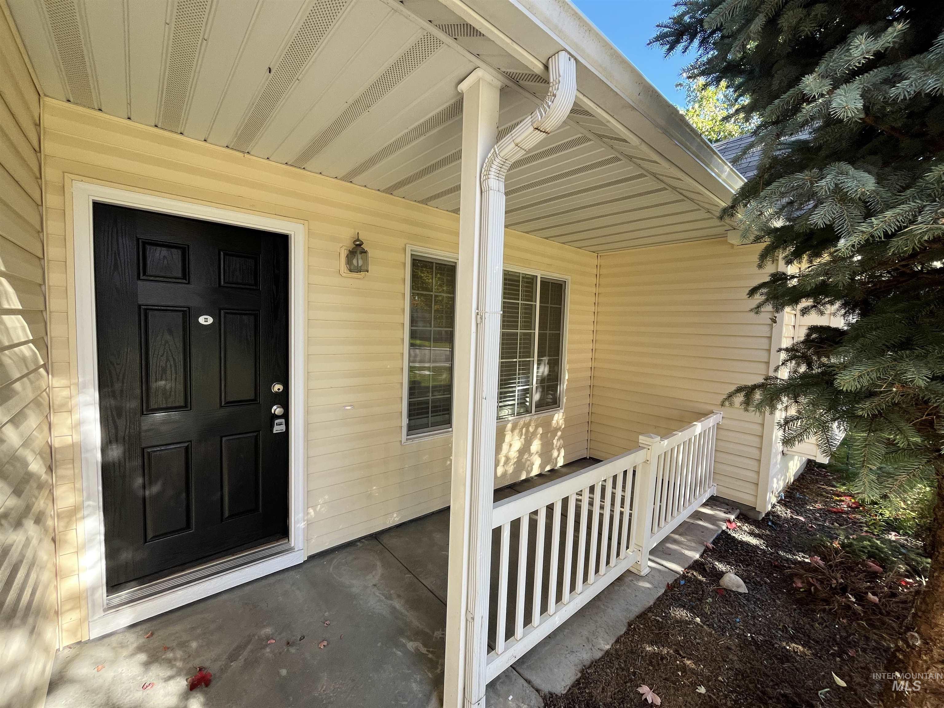 Entrance to property featuring a porch