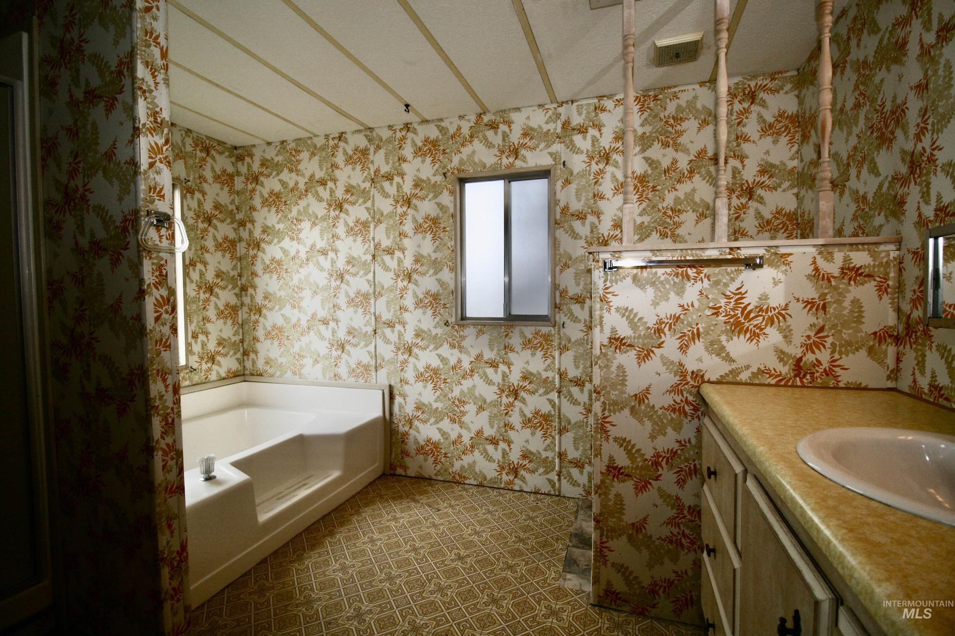 Bathroom featuring a bath and vanity