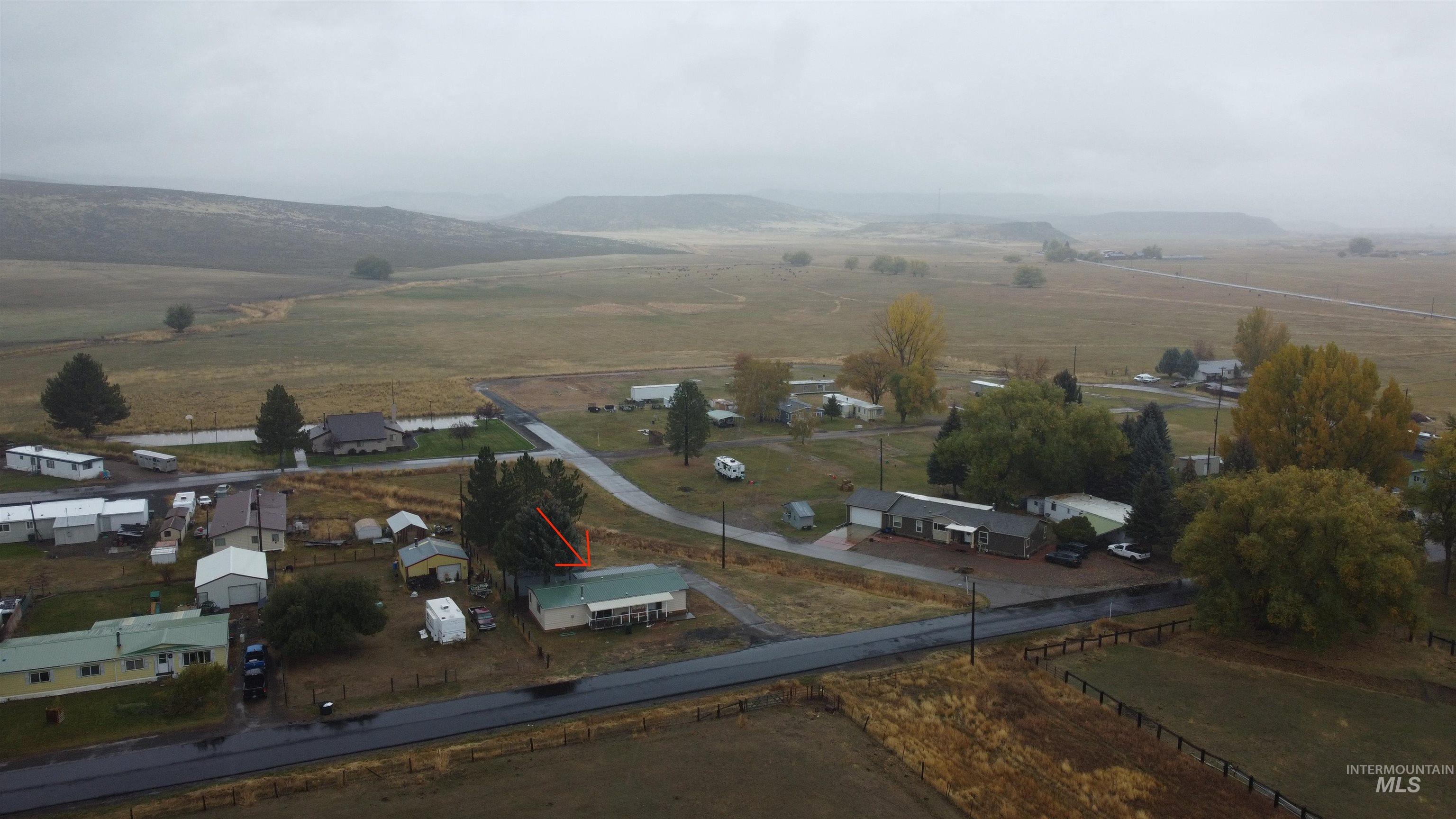 Aerial view of property's location with mountains and rural landscape