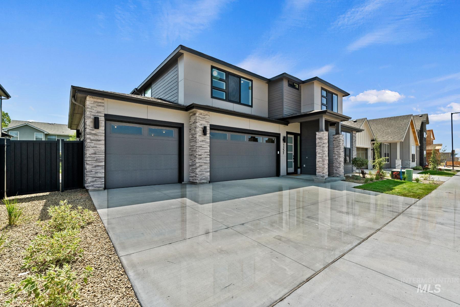 View of front of house featuring stone siding, concrete driveway, stucco siding, and an attached garage