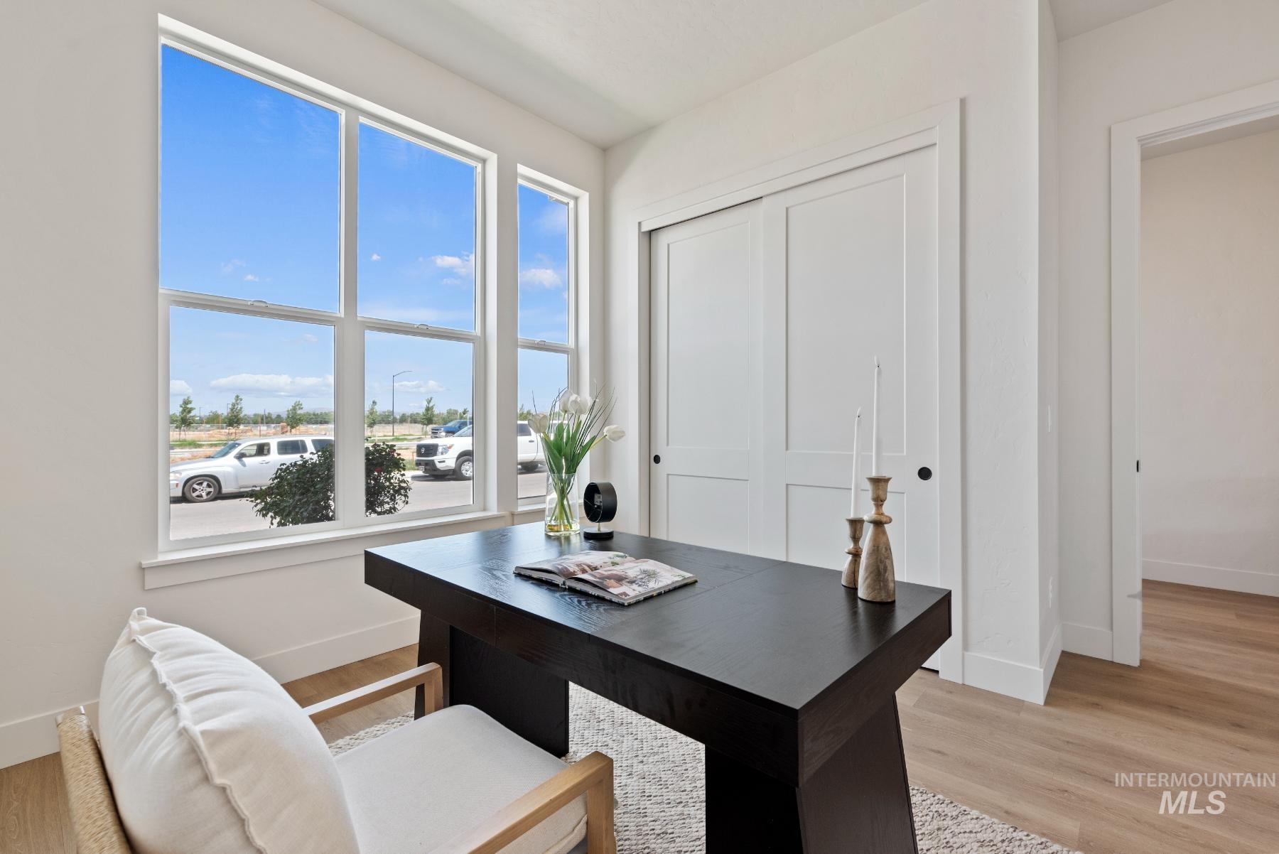 Office space with light wood-type flooring and baseboards