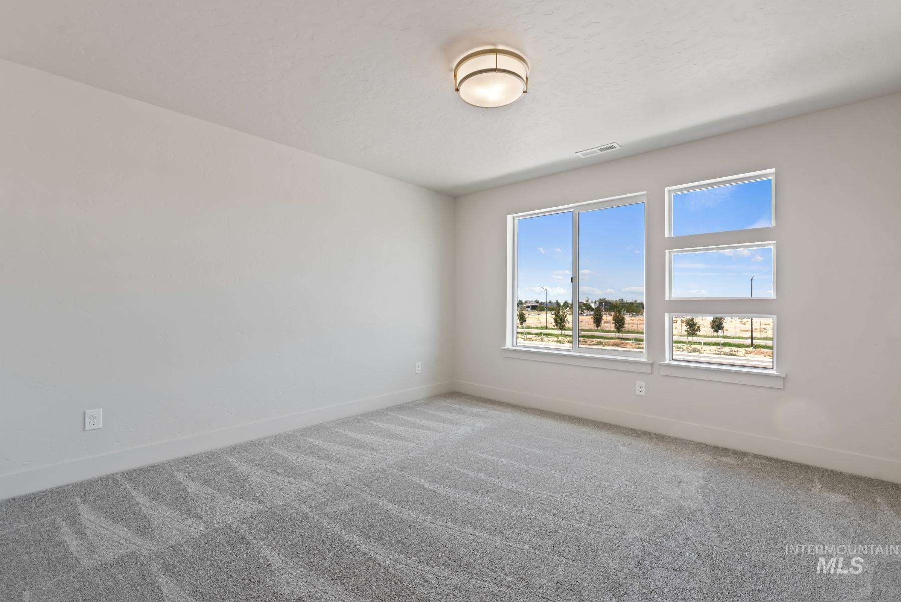 Empty room with carpet flooring and baseboards