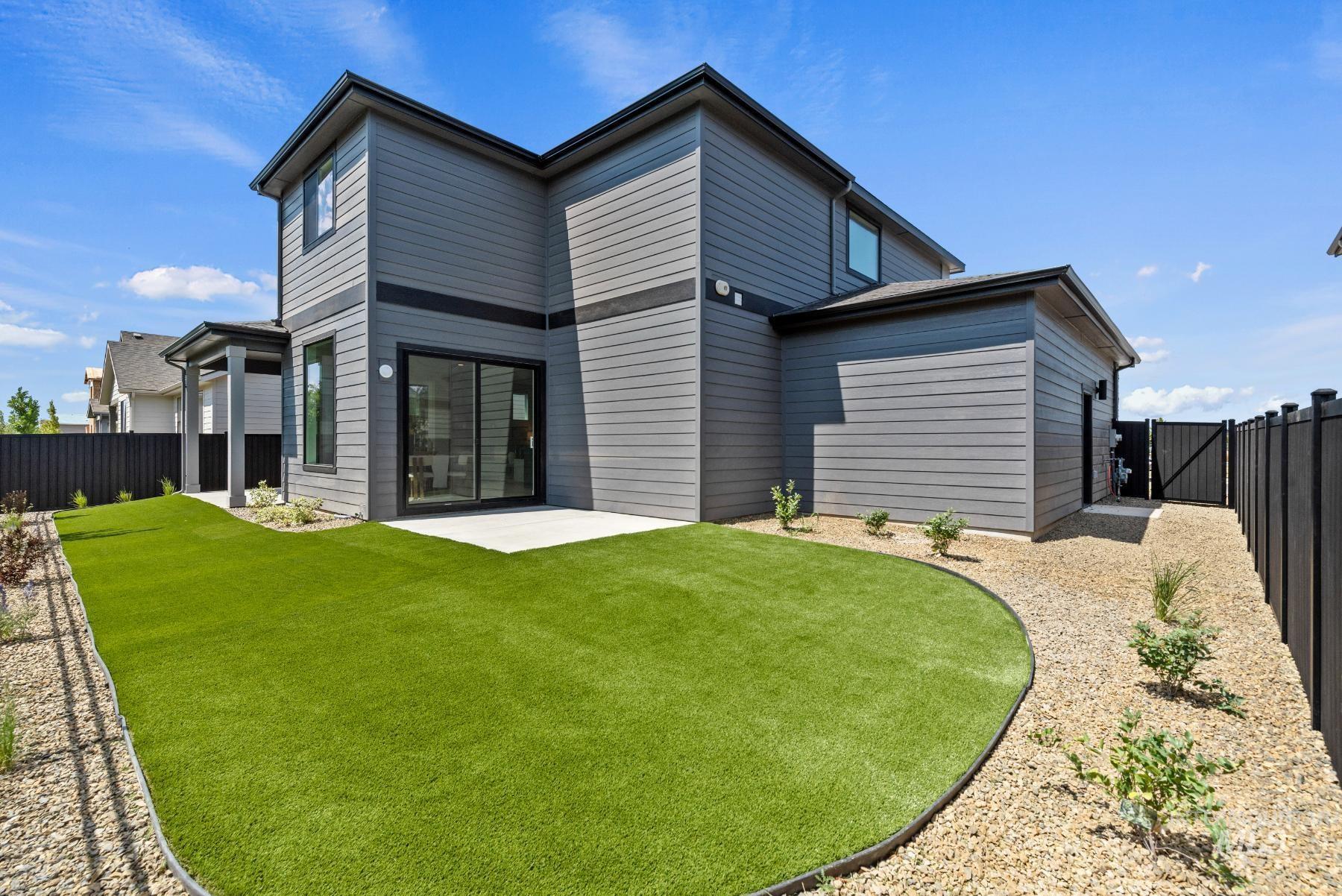 Rear view of property with a fenced backyard, a patio area, and a gate