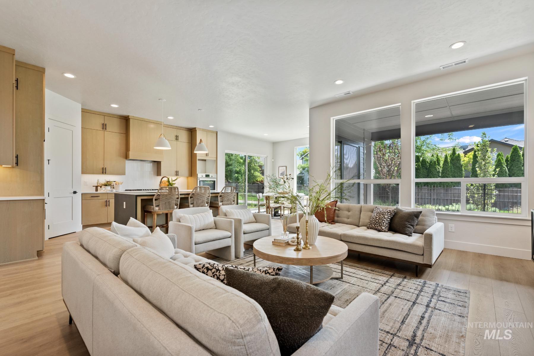 Living area featuring light wood-style flooring and recessed lighting