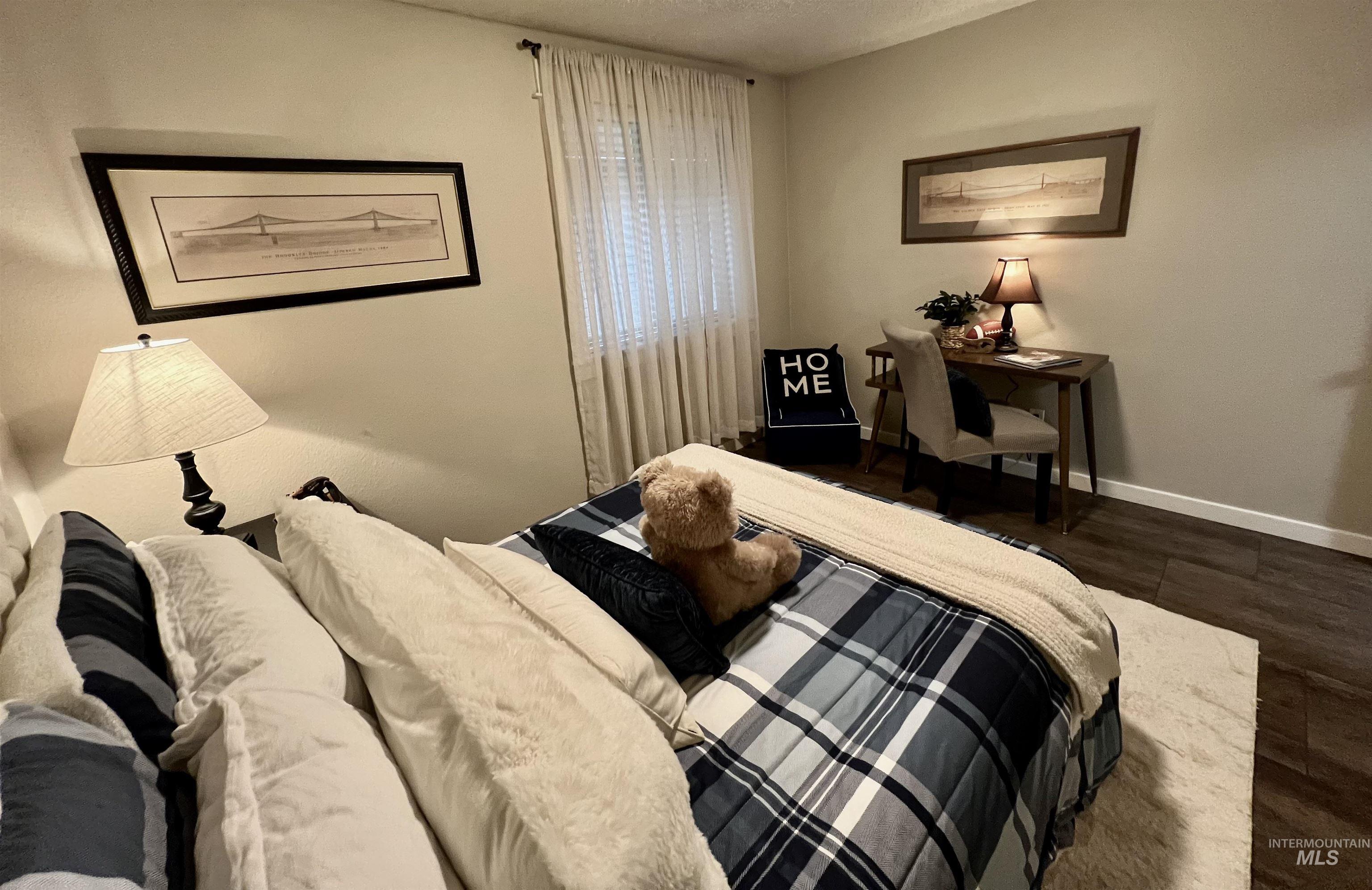 Bedroom featuring dark wood-type flooring and a textured ceiling