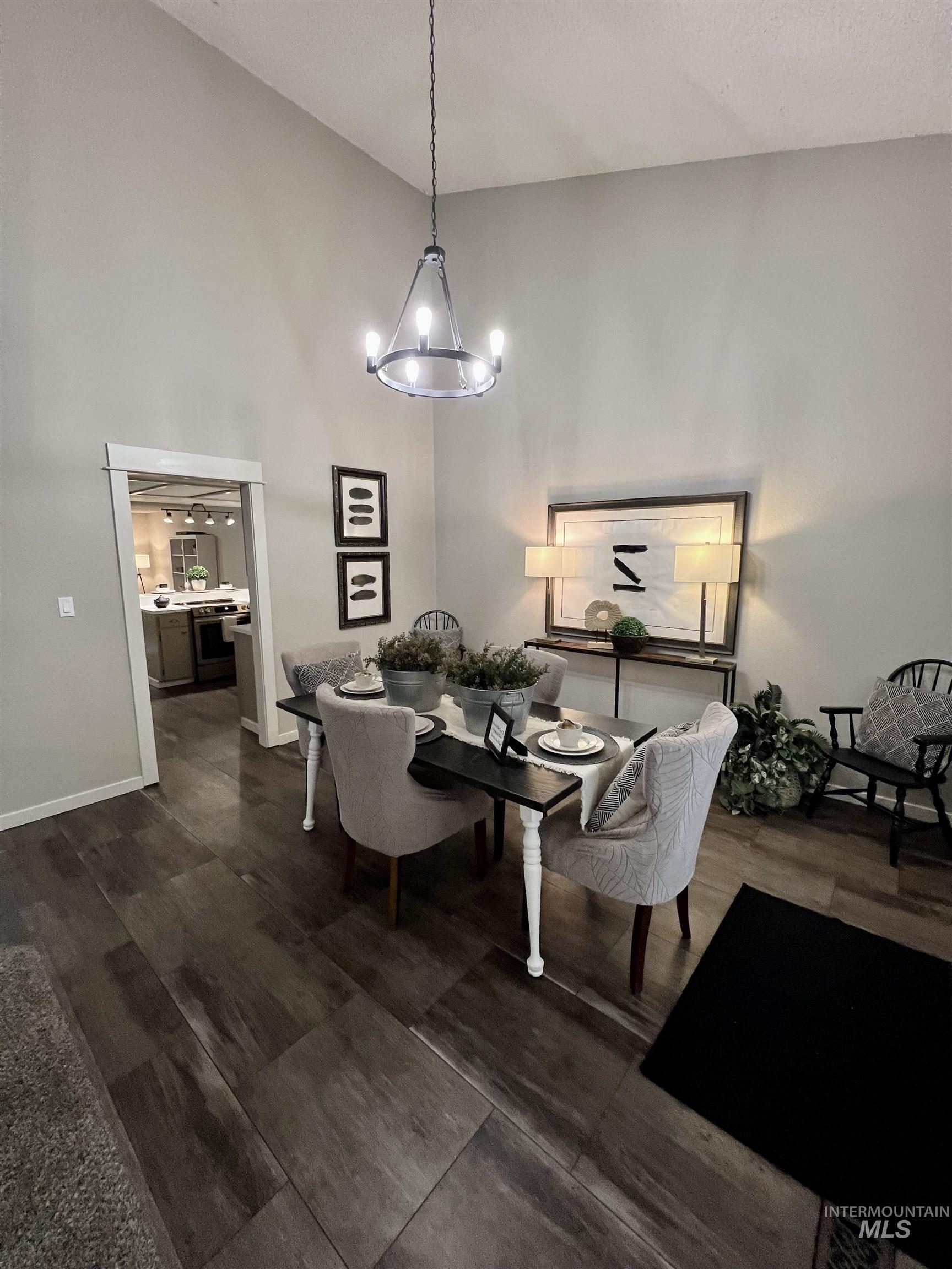 Dining area featuring high vaulted ceiling