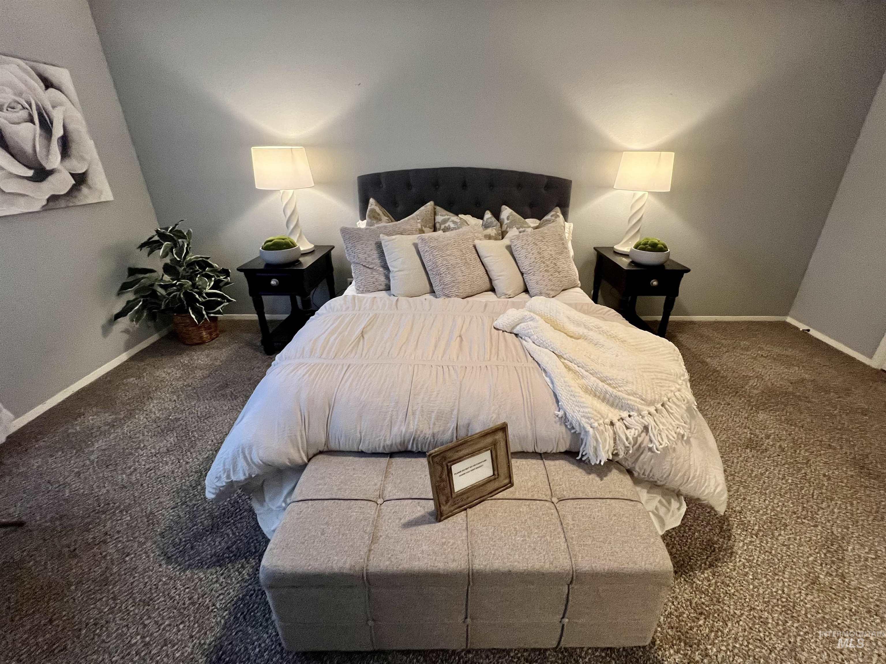 Bedroom featuring carpet floors and baseboards