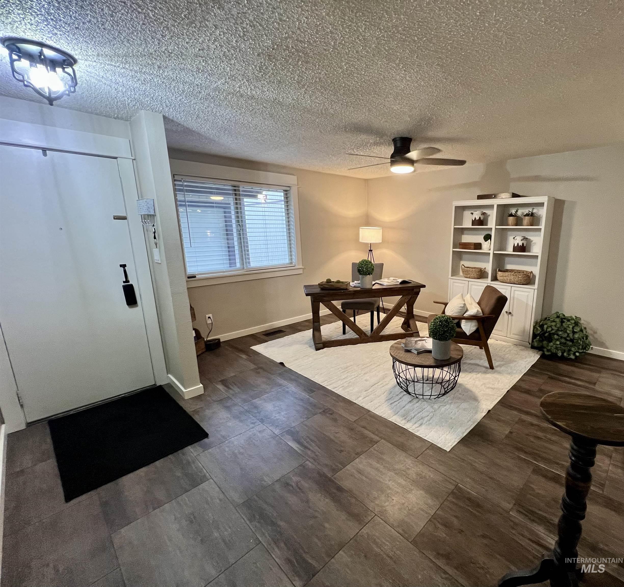 Foyer with a textured ceiling and a ceiling fan