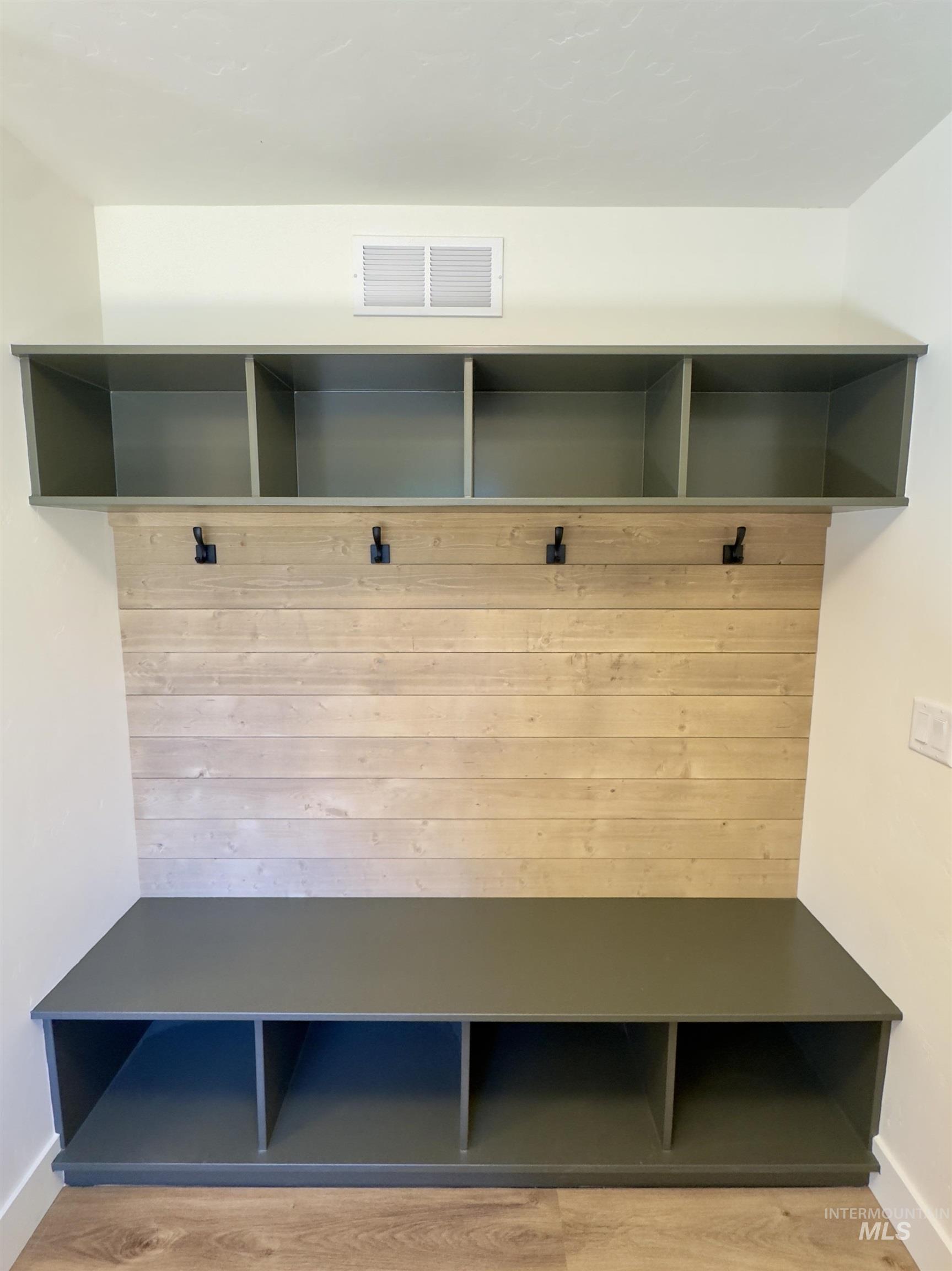 Mudroom with baseboards and light wood-style flooring